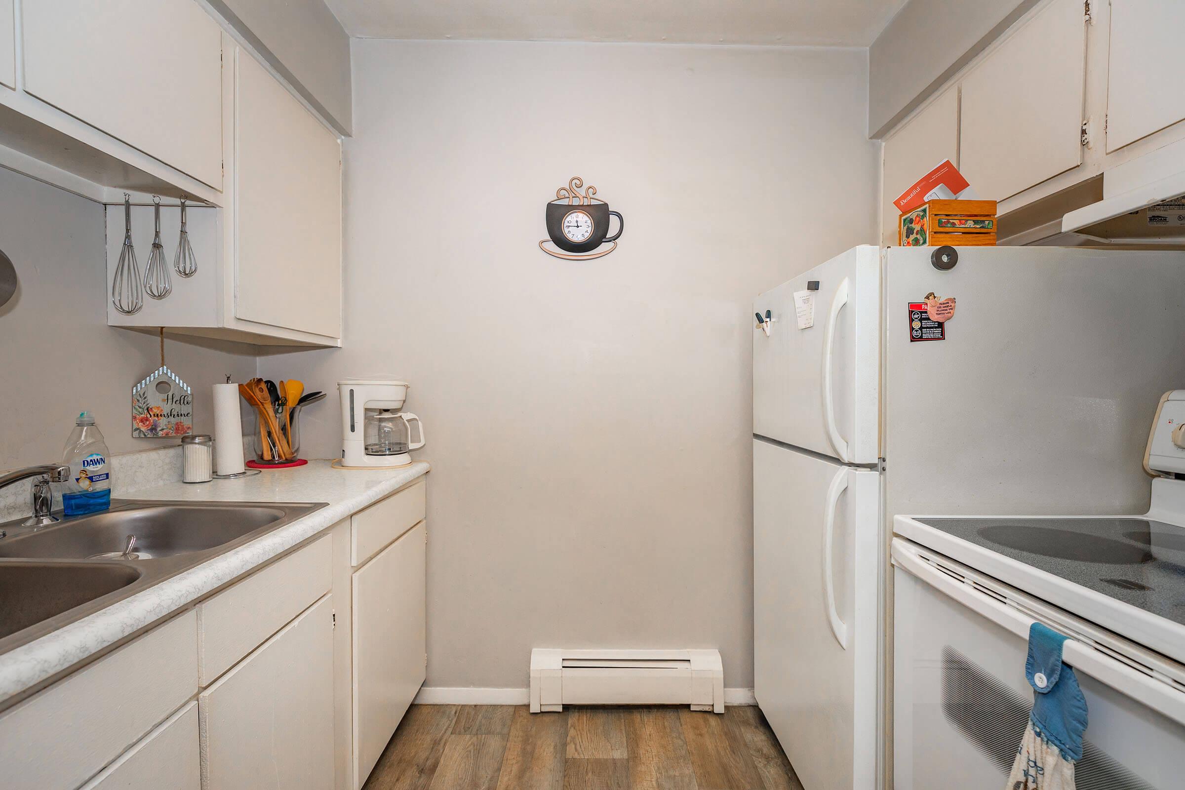 a kitchen with a sink and a refrigerator