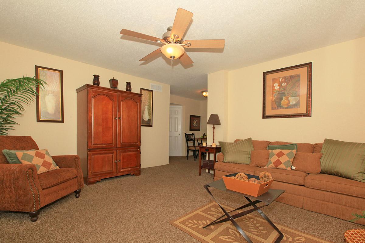 a living room filled with furniture and a lamp