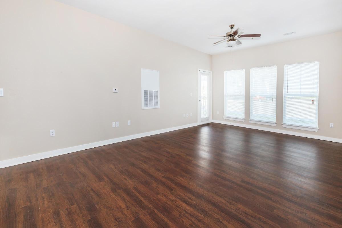 a large empty room with a wood floor