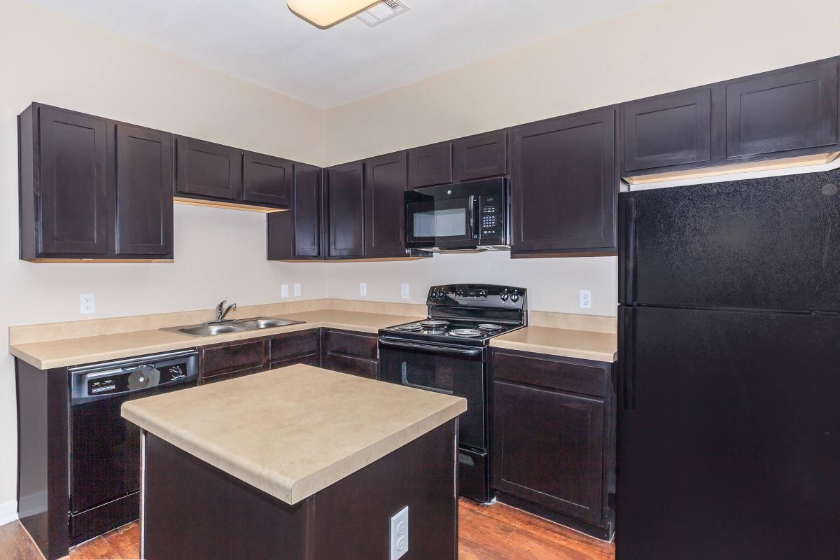 a modern kitchen with stainless steel appliances and wooden cabinets