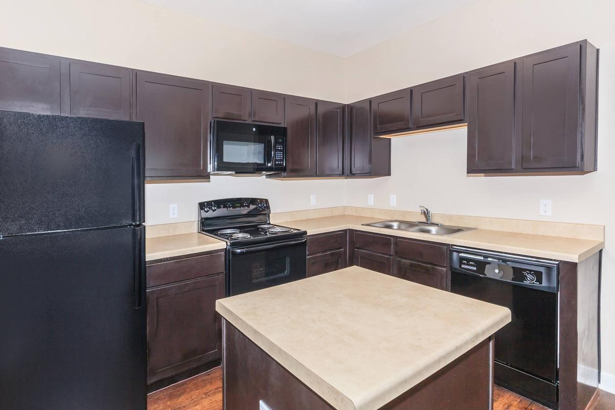 a modern kitchen with stainless steel appliances and wooden cabinets
