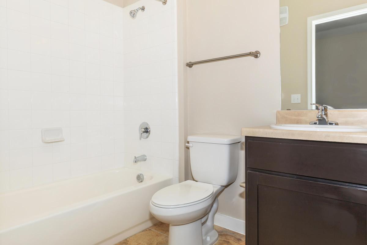 a white tub sitting next to a shower
