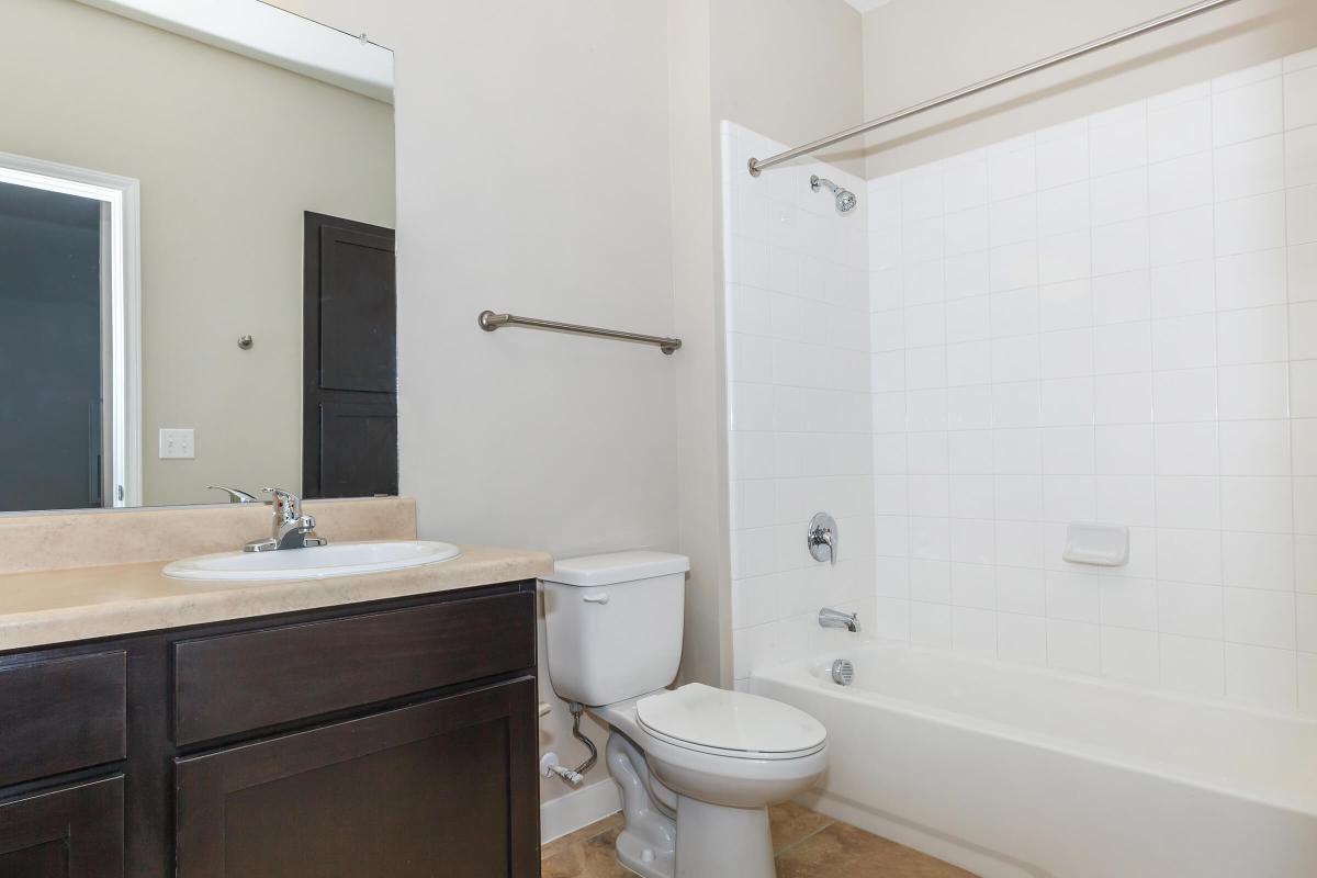 a white tub sitting next to a sink