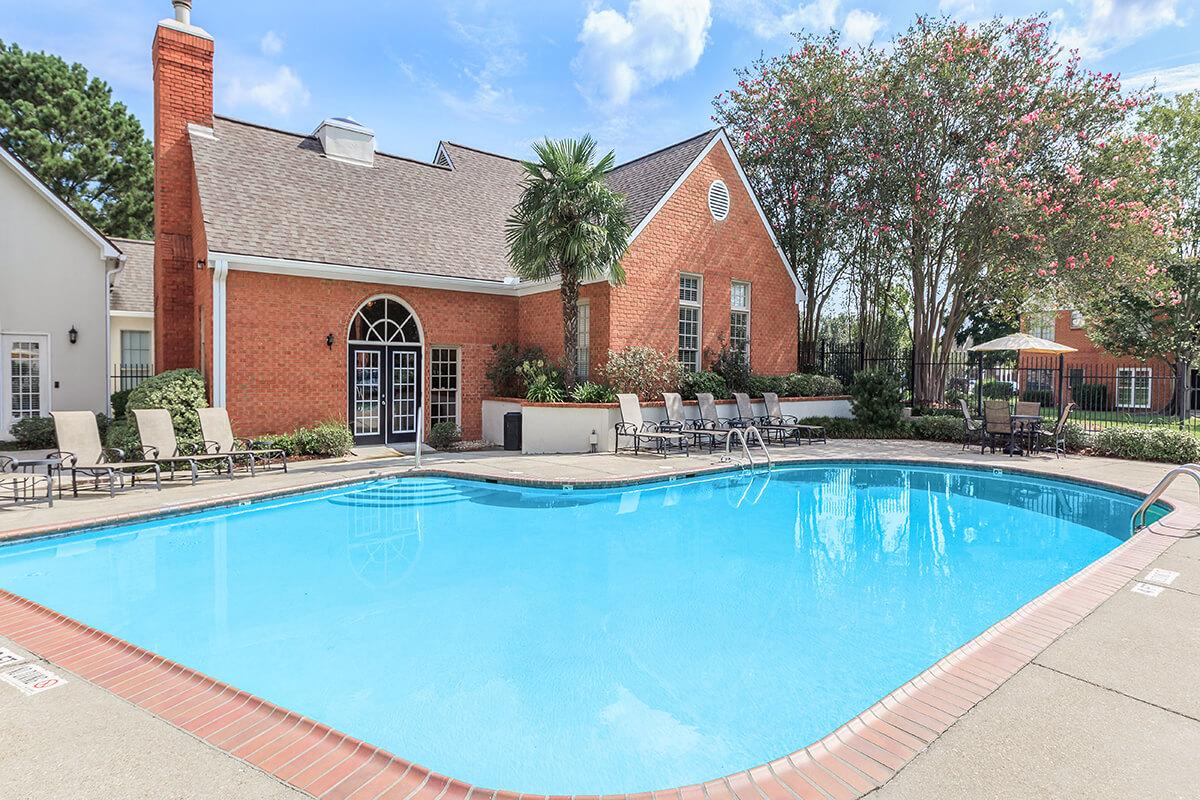 a house with a pool in front of a building