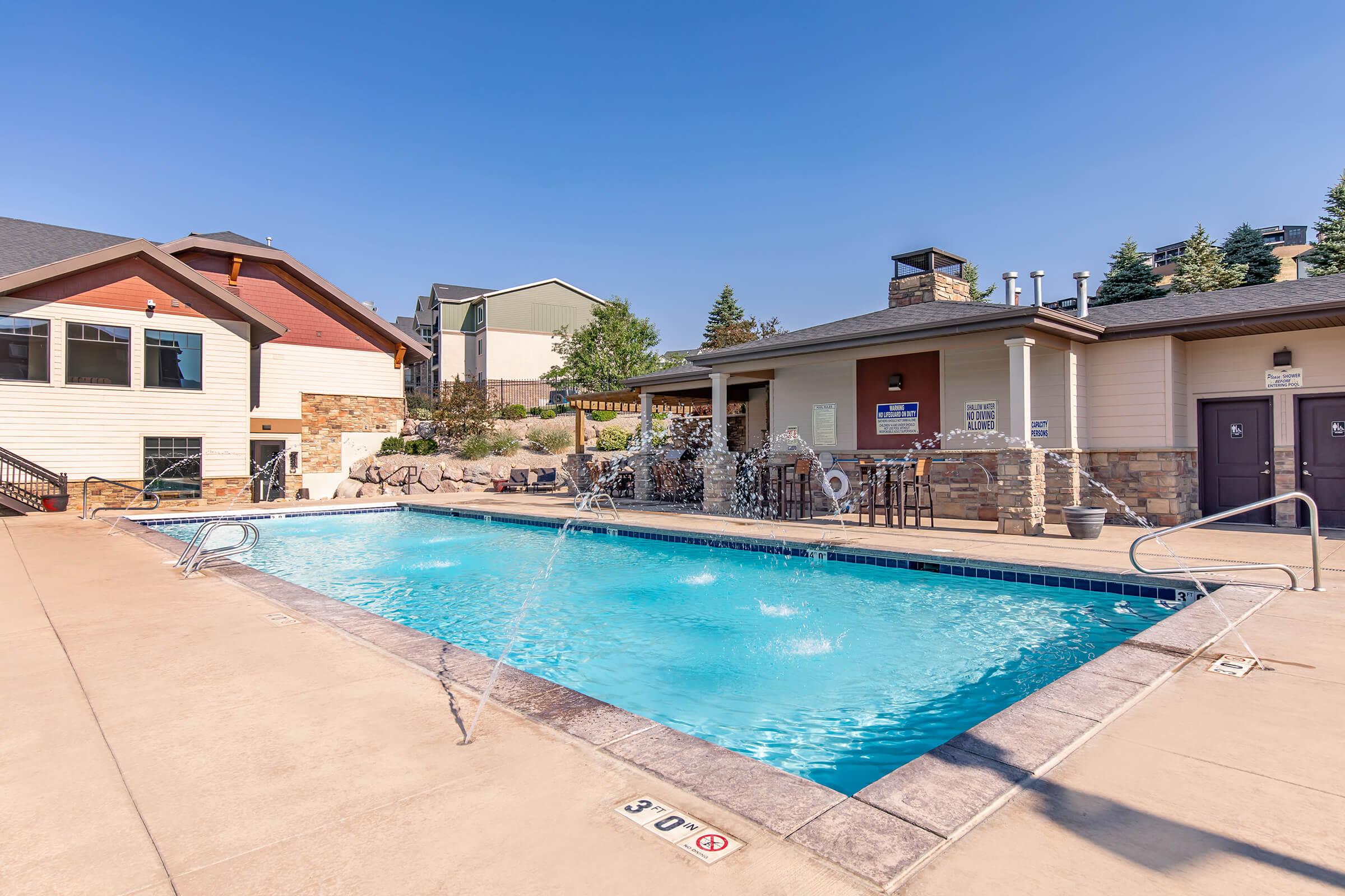 a house with a pool in front of a building