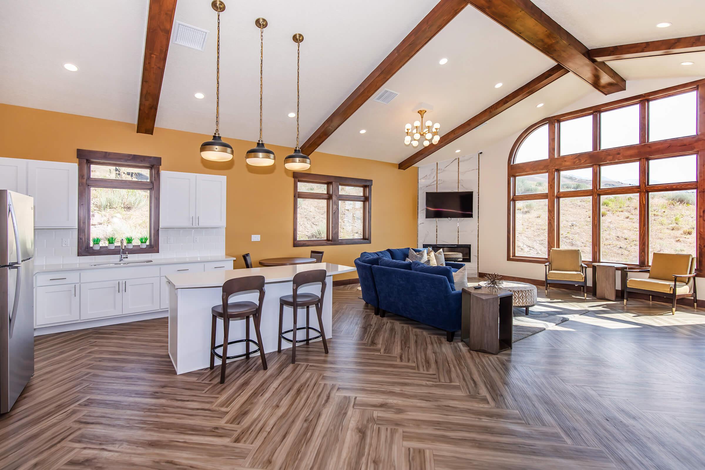 a living room filled with furniture on top of a hard wood floor