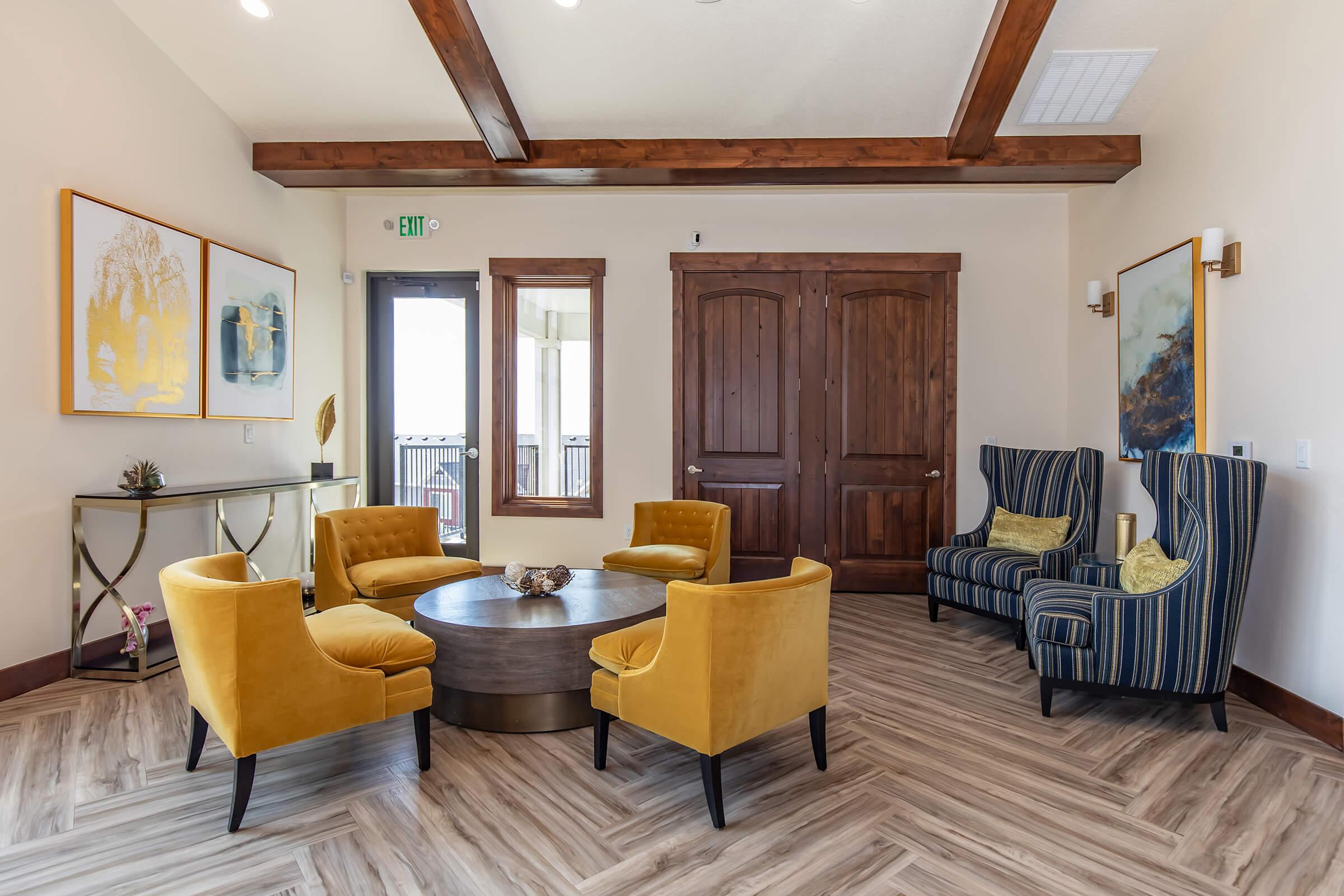 a living room filled with furniture on top of a wooden floor