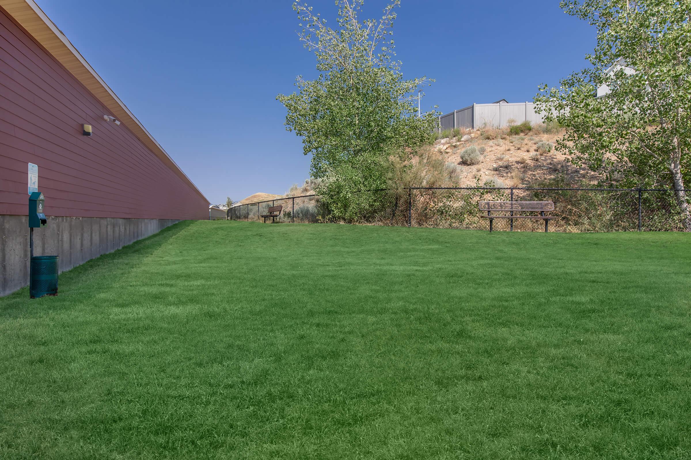 a large green field in front of a house