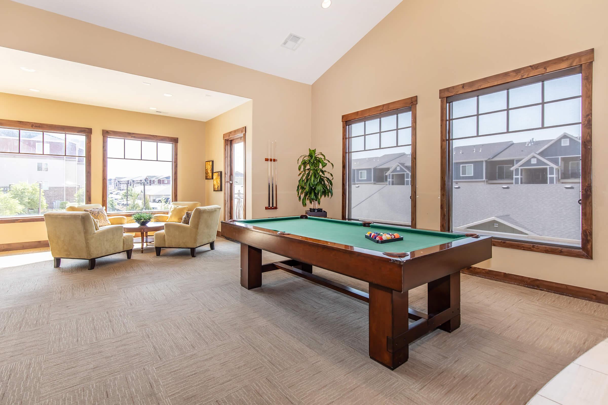 a living room filled with furniture and a large window