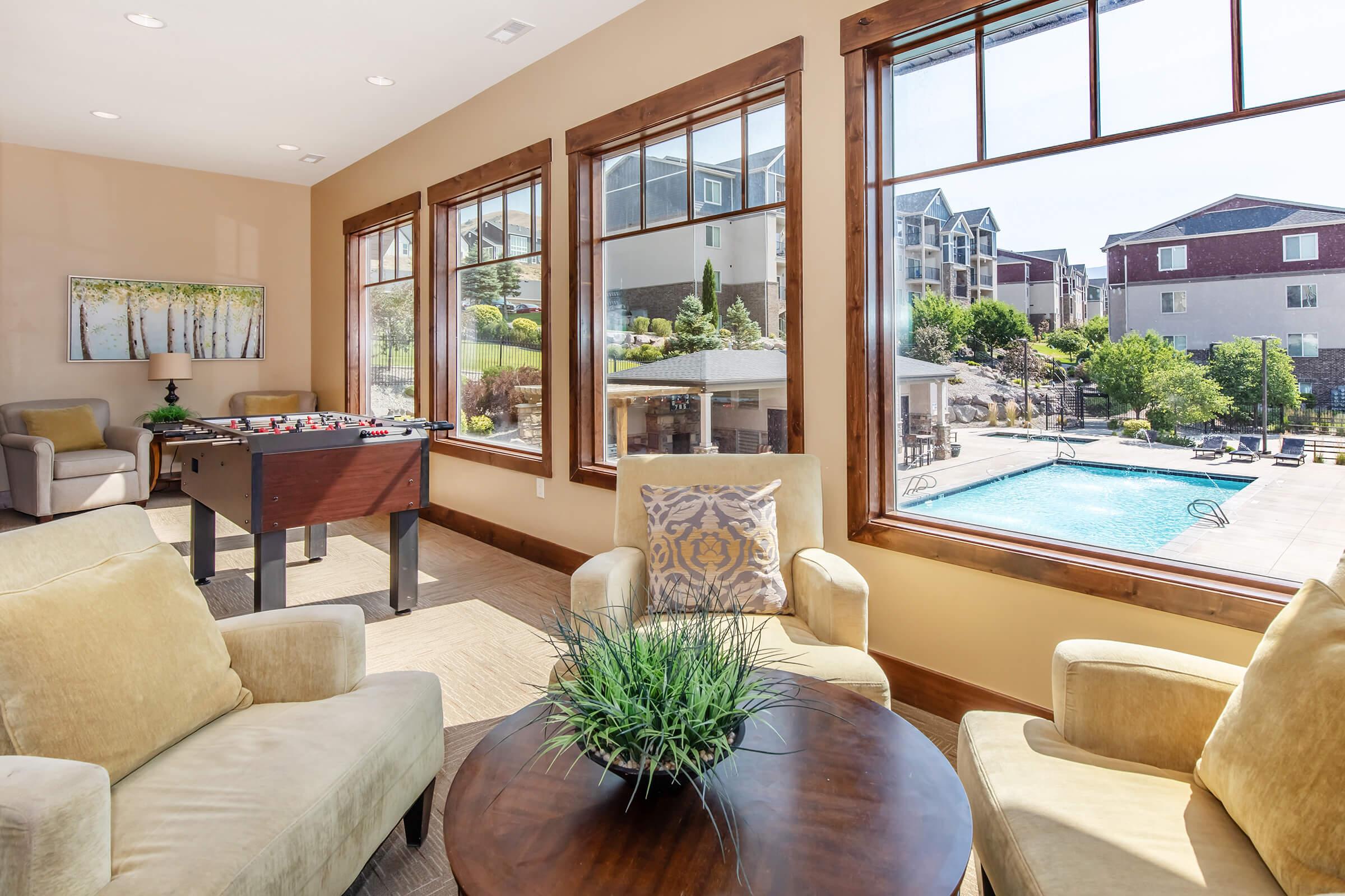 a living room filled with furniture and a large window