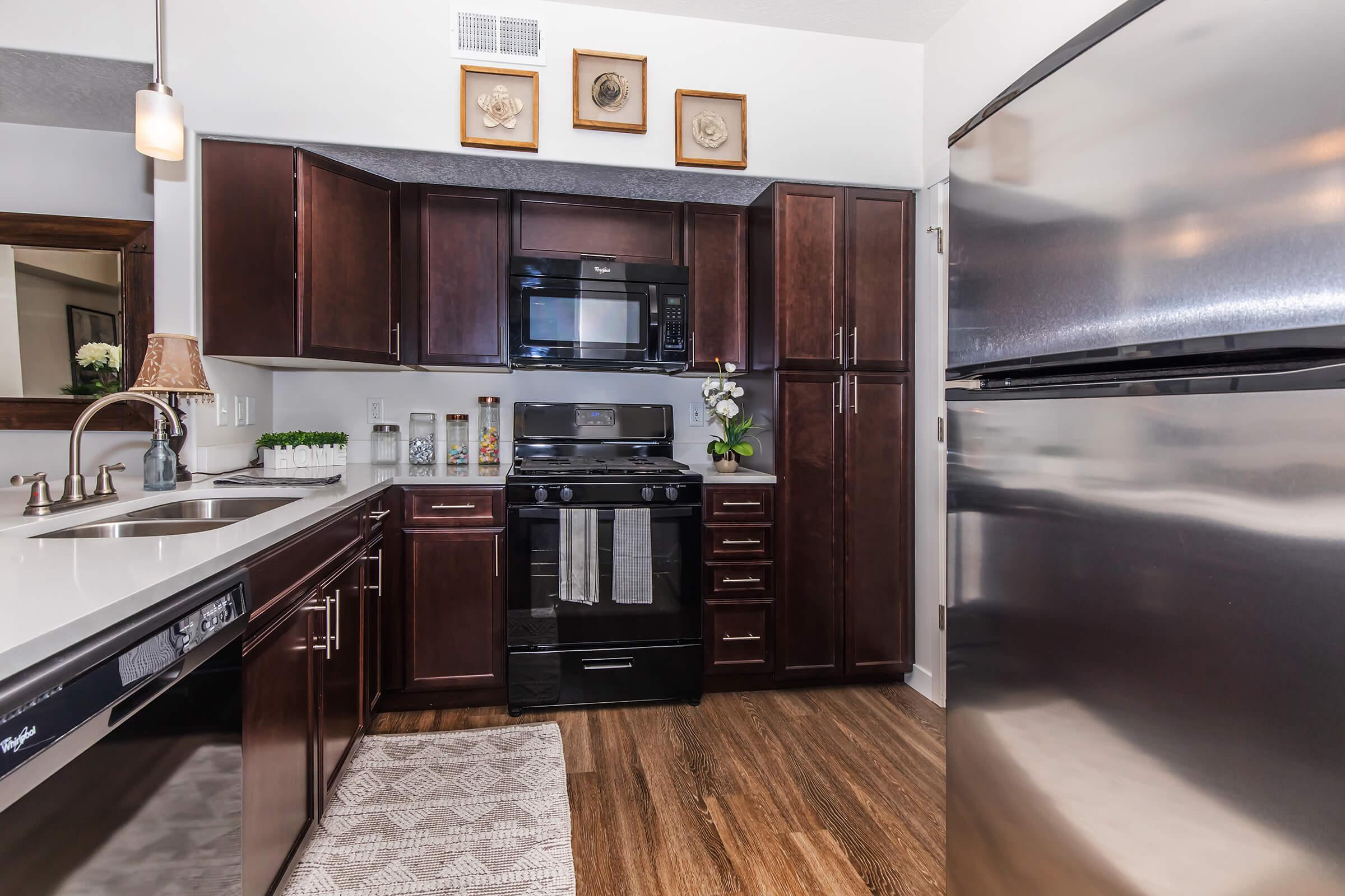 a kitchen with stainless steel appliances and wooden cabinets