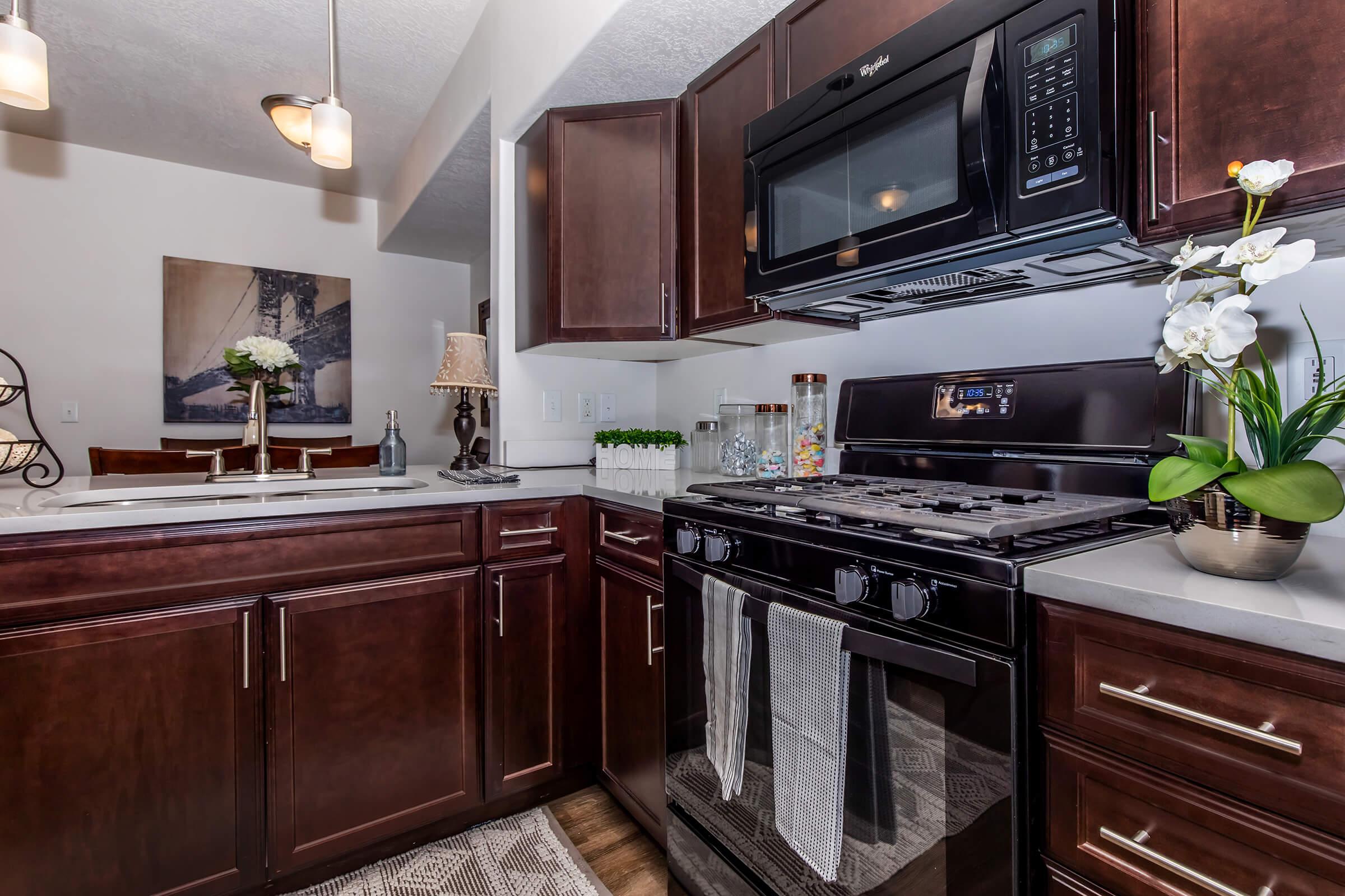 a kitchen with stainless steel appliances and wooden cabinets