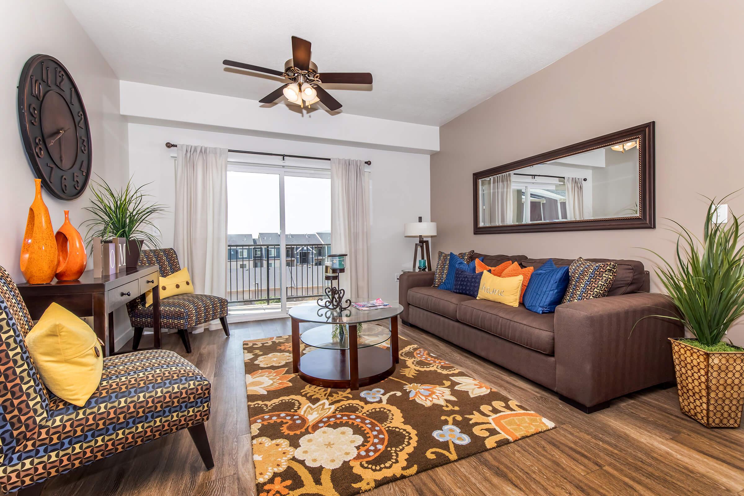 a living room filled with furniture and a large window