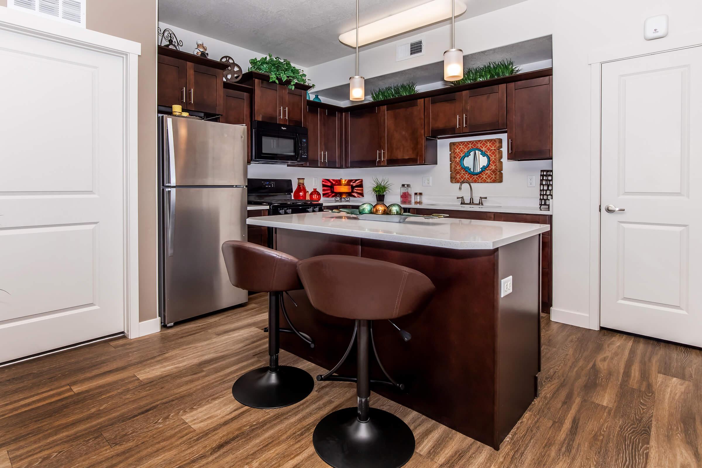 a kitchen with a table in front of a window