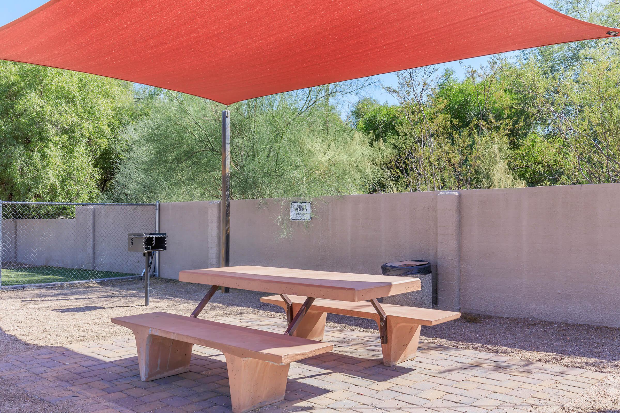 an umbrella sitting on top of a wooden bench