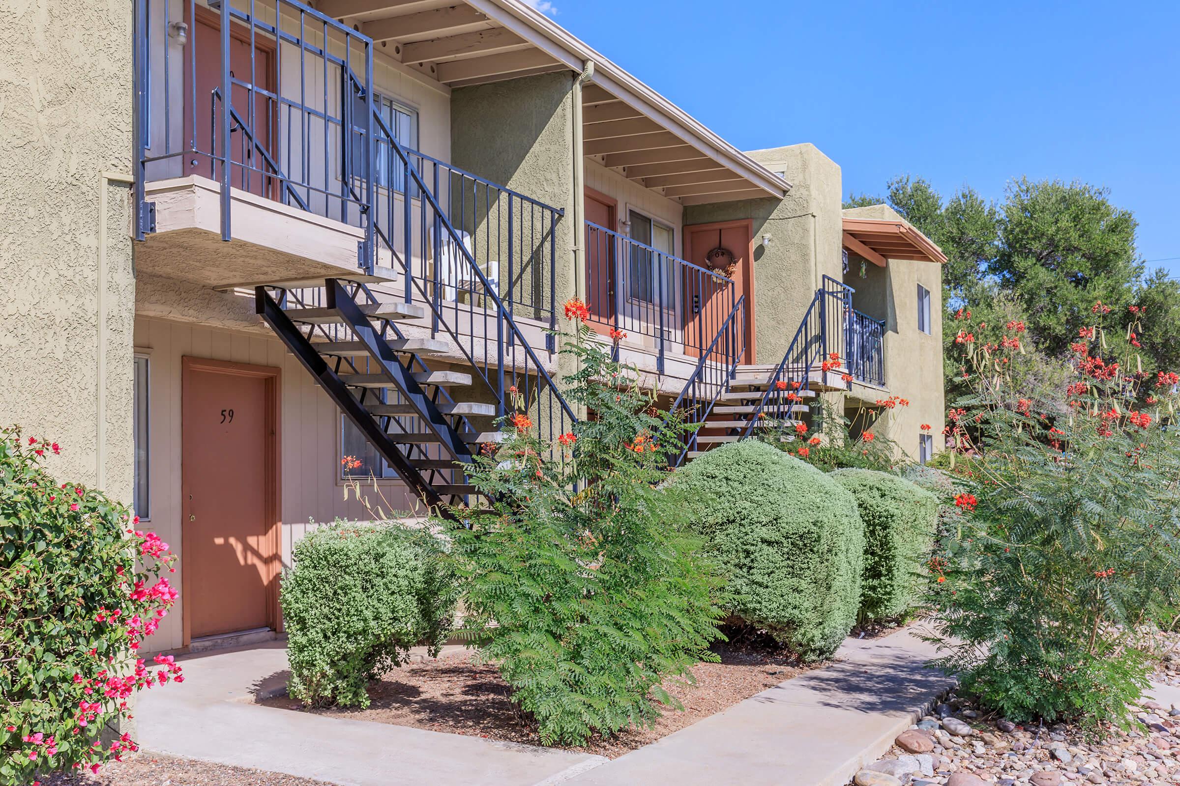 a house with bushes in front of a building