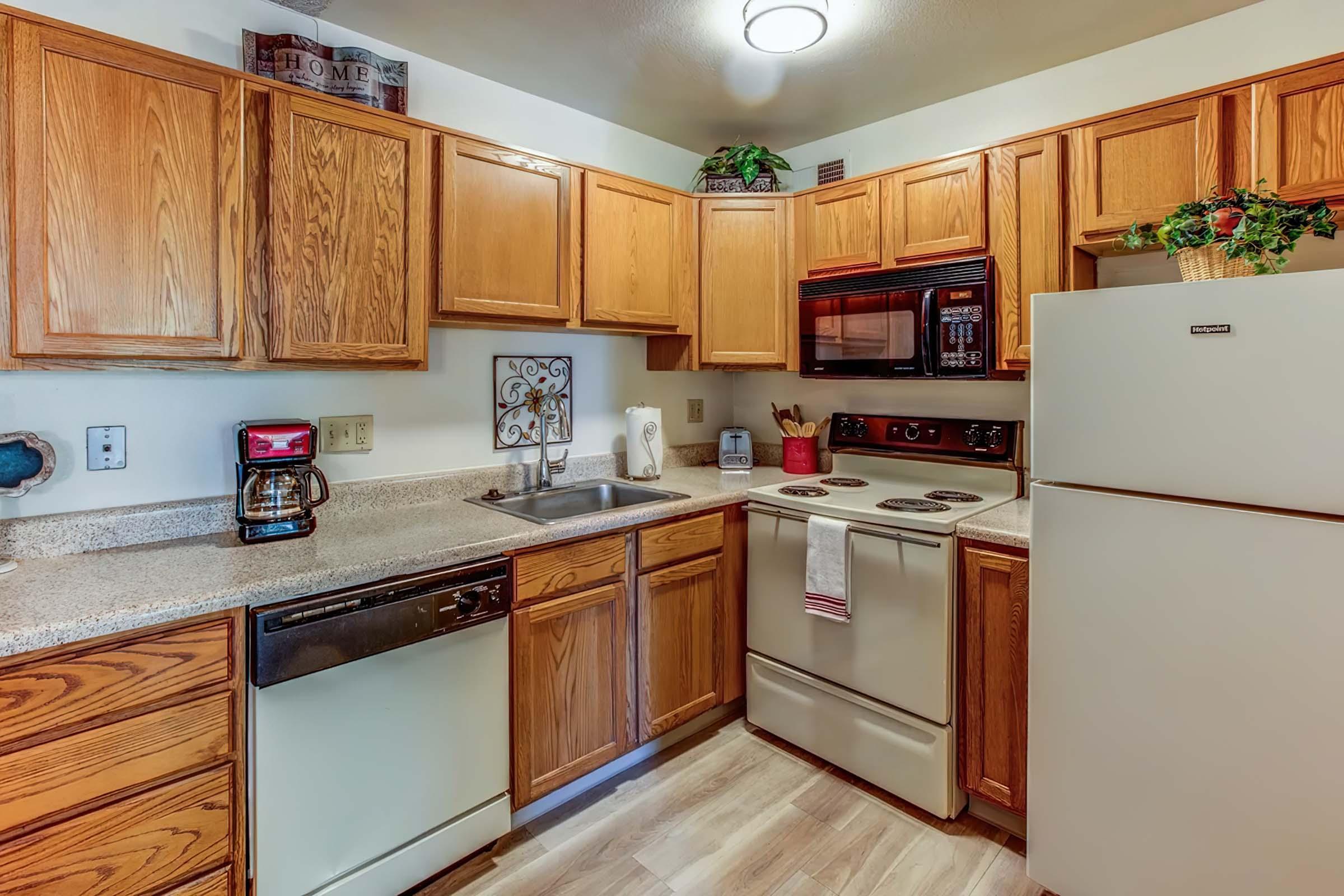 a kitchen with stainless steel appliances and wooden cabinets