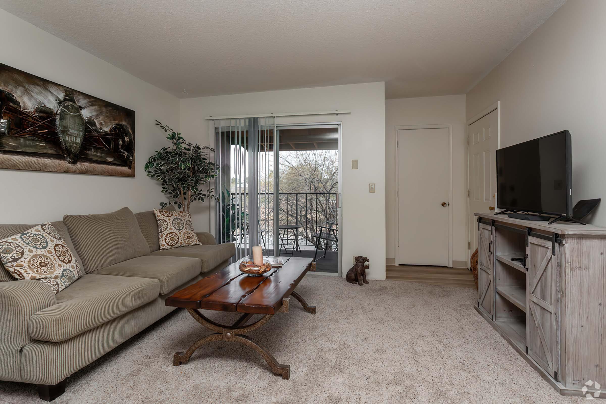 a living room filled with furniture and a bed