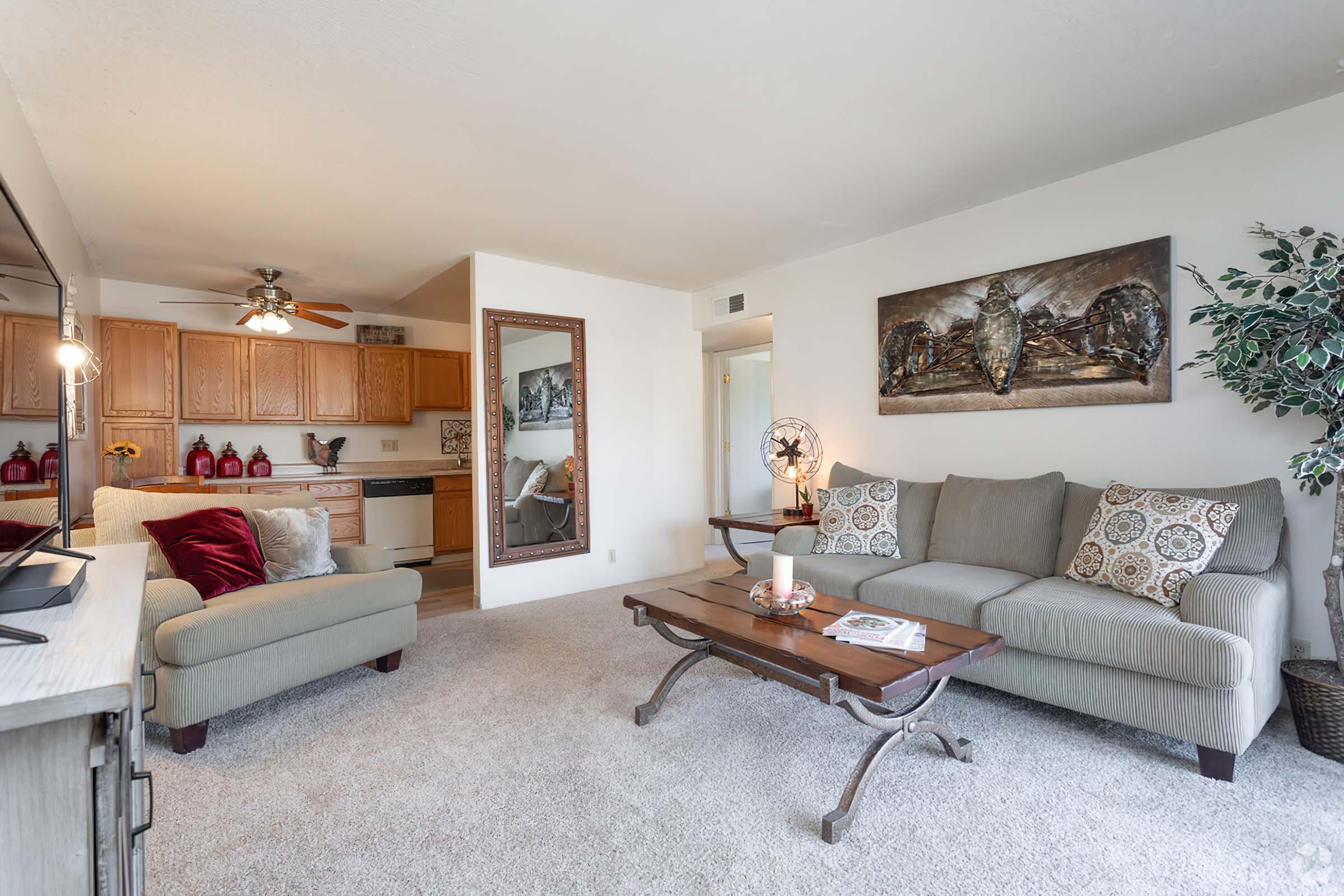 a living room filled with furniture and a bed