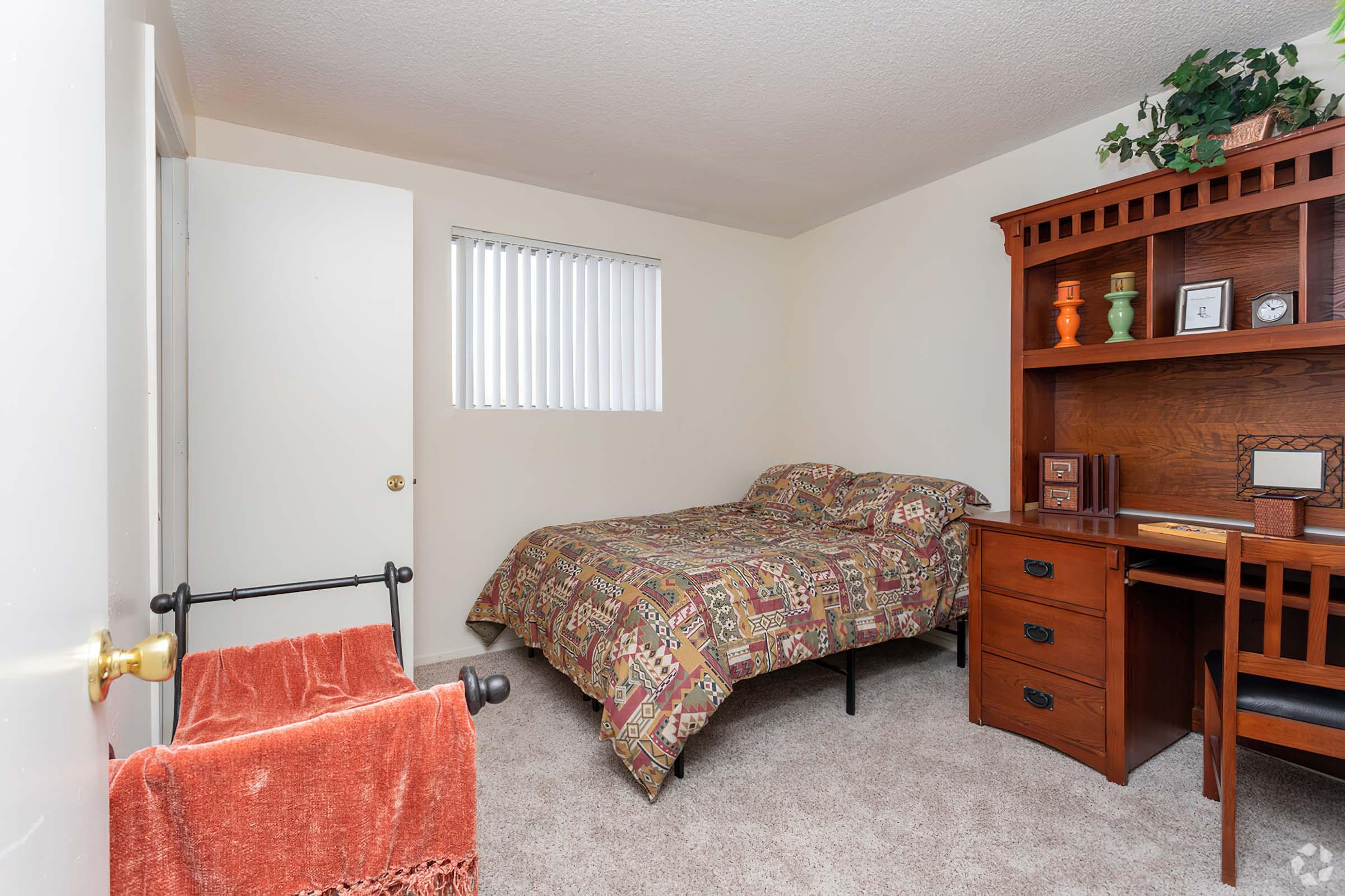 a living room filled with furniture and a bed