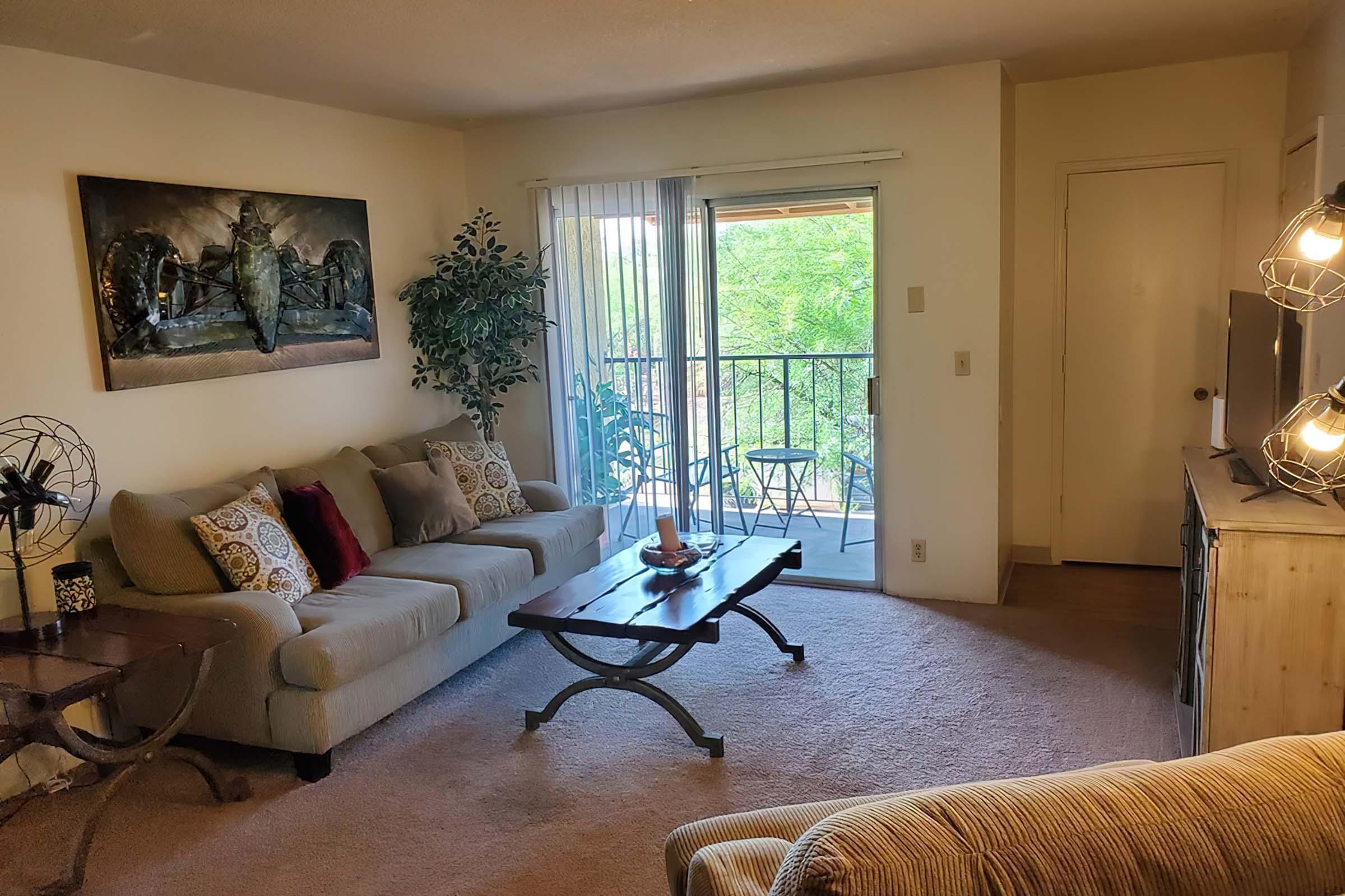 a bedroom with a bed and a couch in a living room