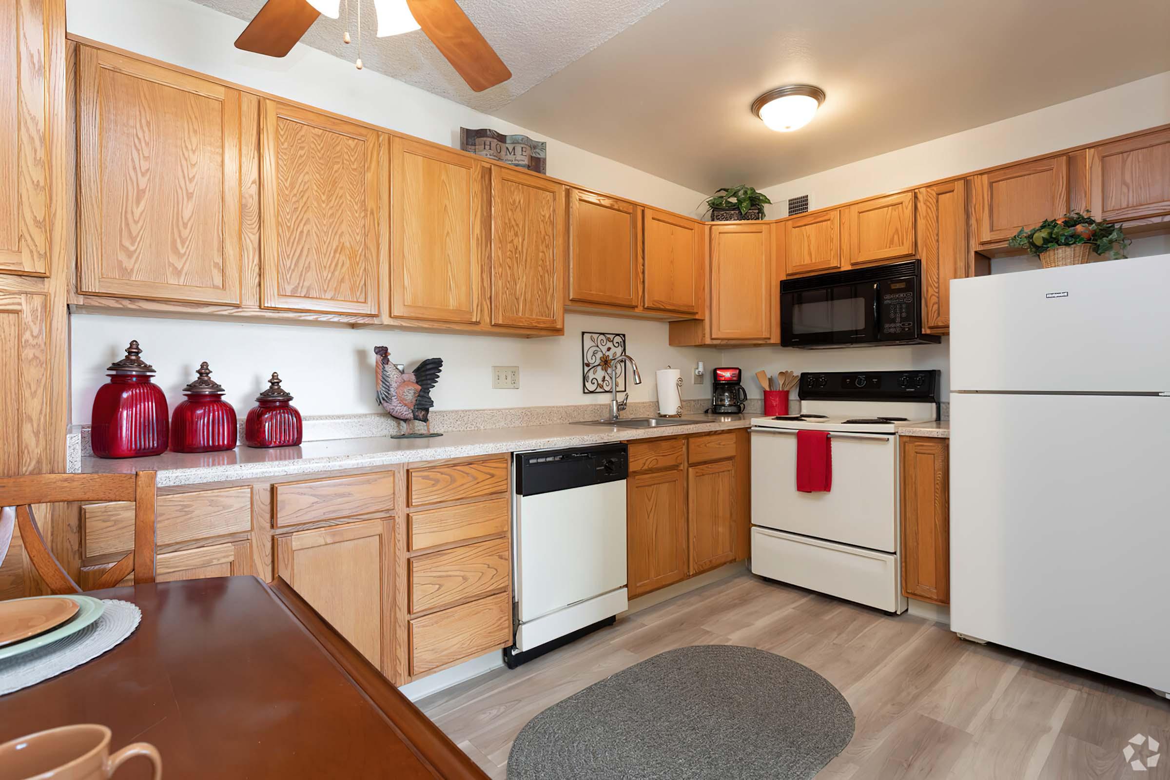 a kitchen with stainless steel appliances and wooden cabinets