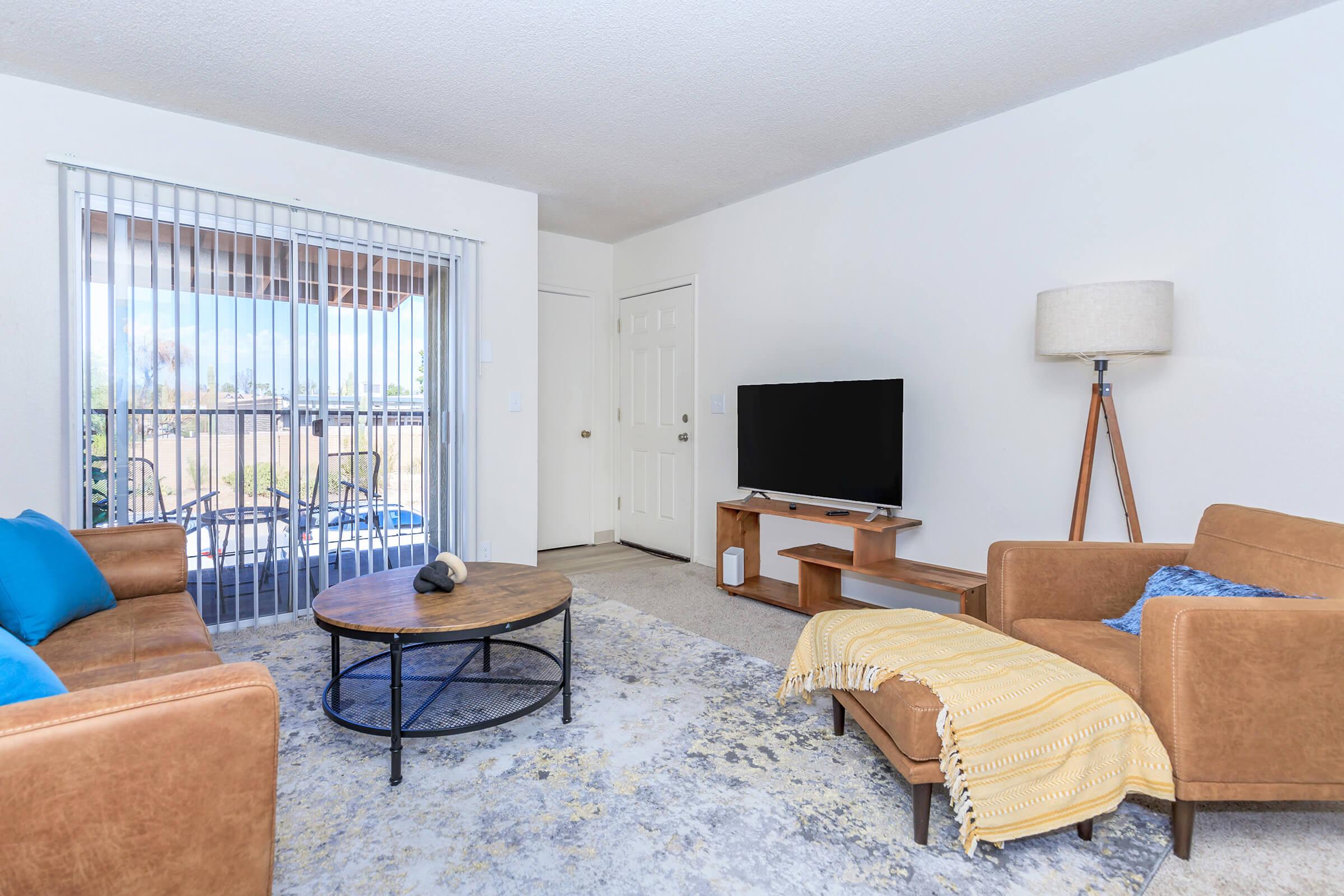 a living room filled with furniture and a large window