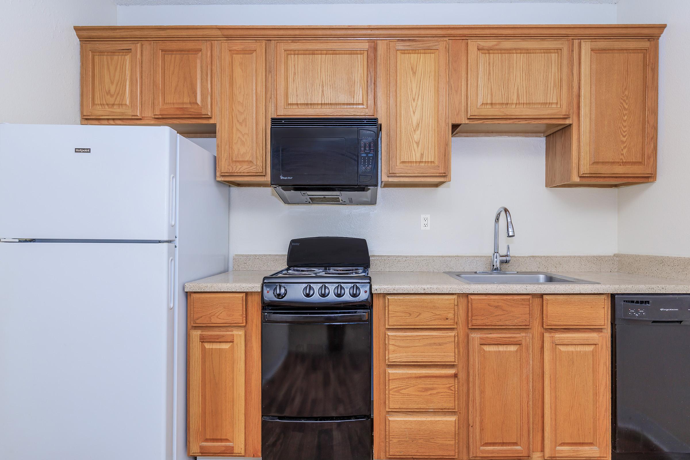 a kitchen with a stove top oven sitting inside of a refrigerator