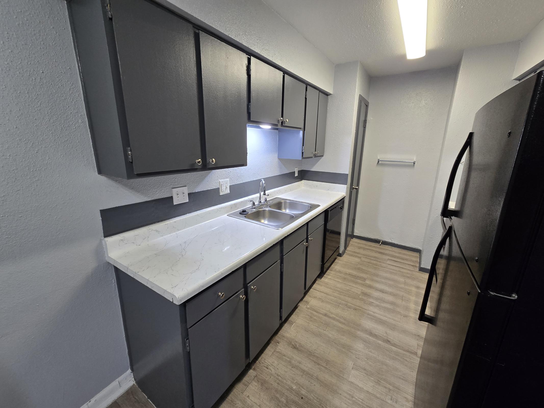 a kitchen with a sink and a mirror