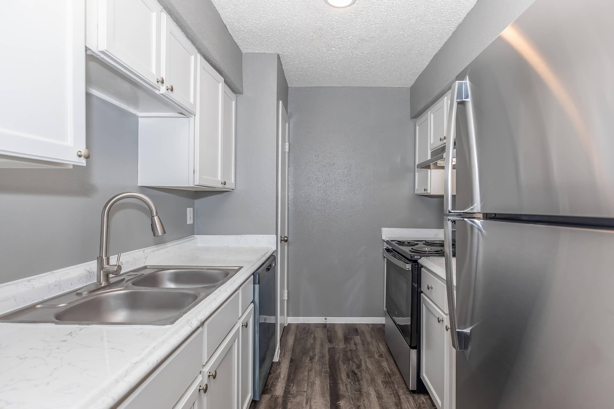 a kitchen with a sink and a refrigerator