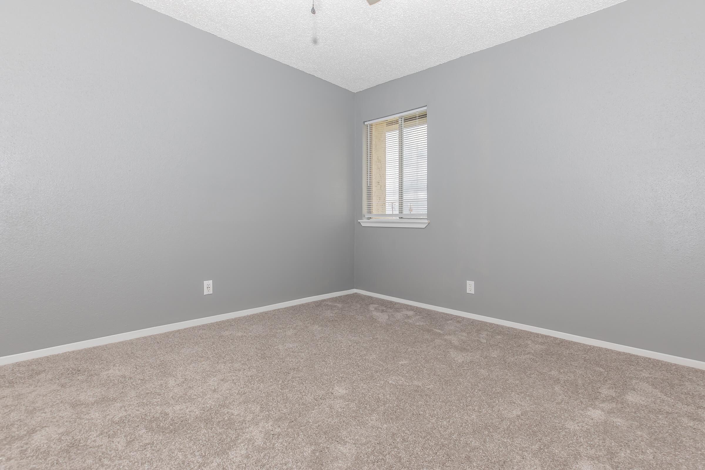 a bedroom with a large window