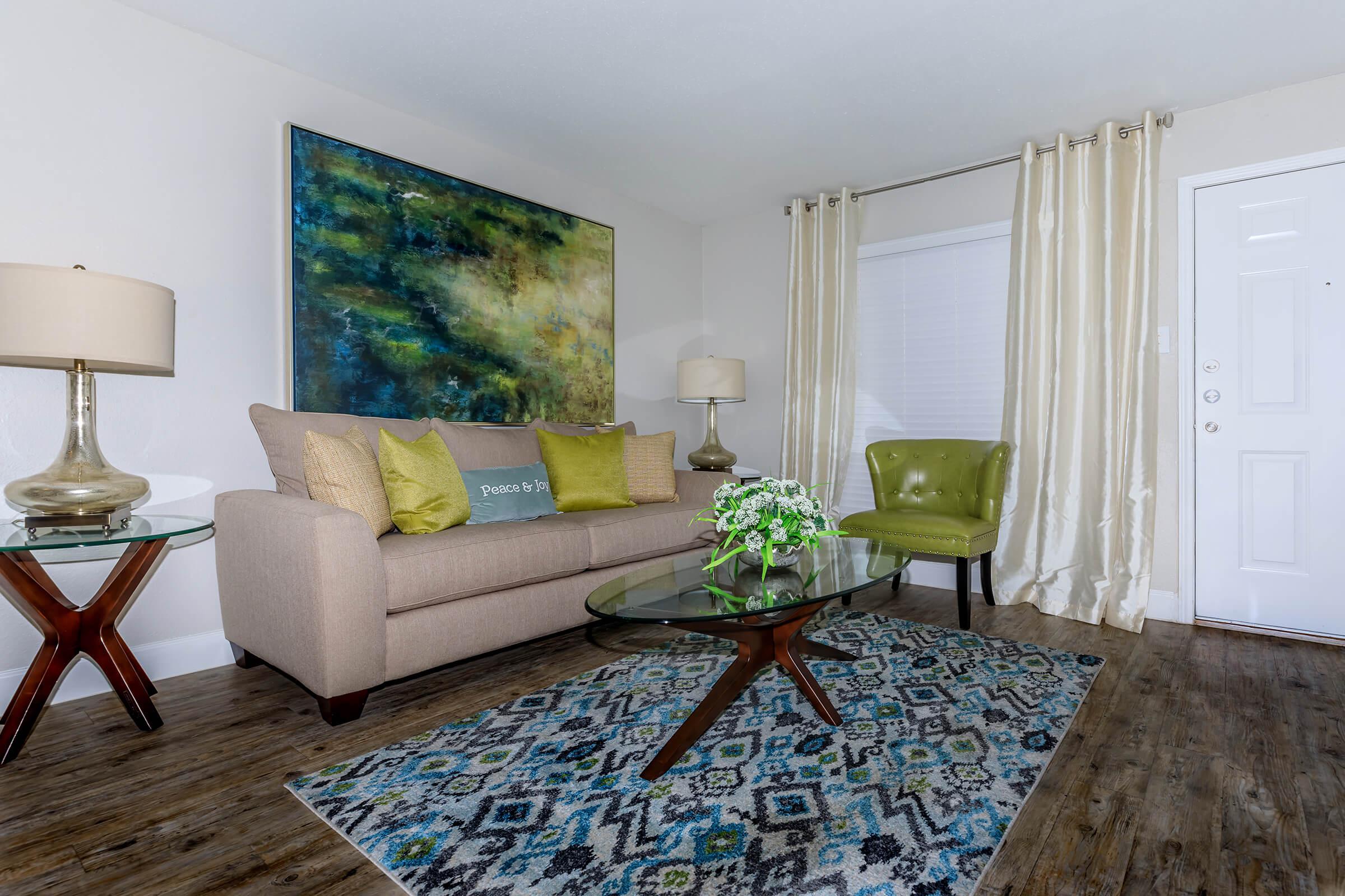 a living room filled with furniture and a flat screen tv
