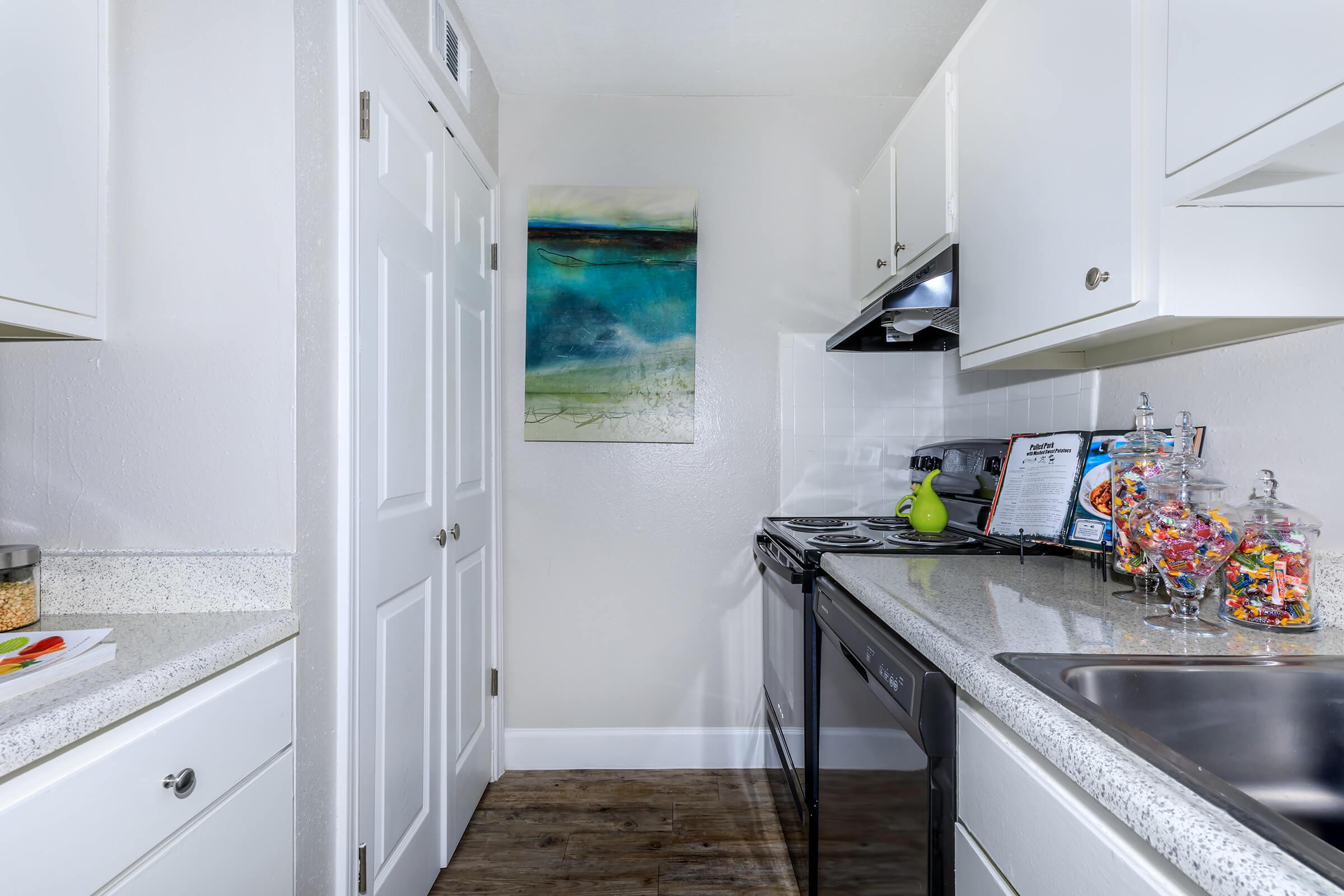 a kitchen with a stove a sink and a microwave