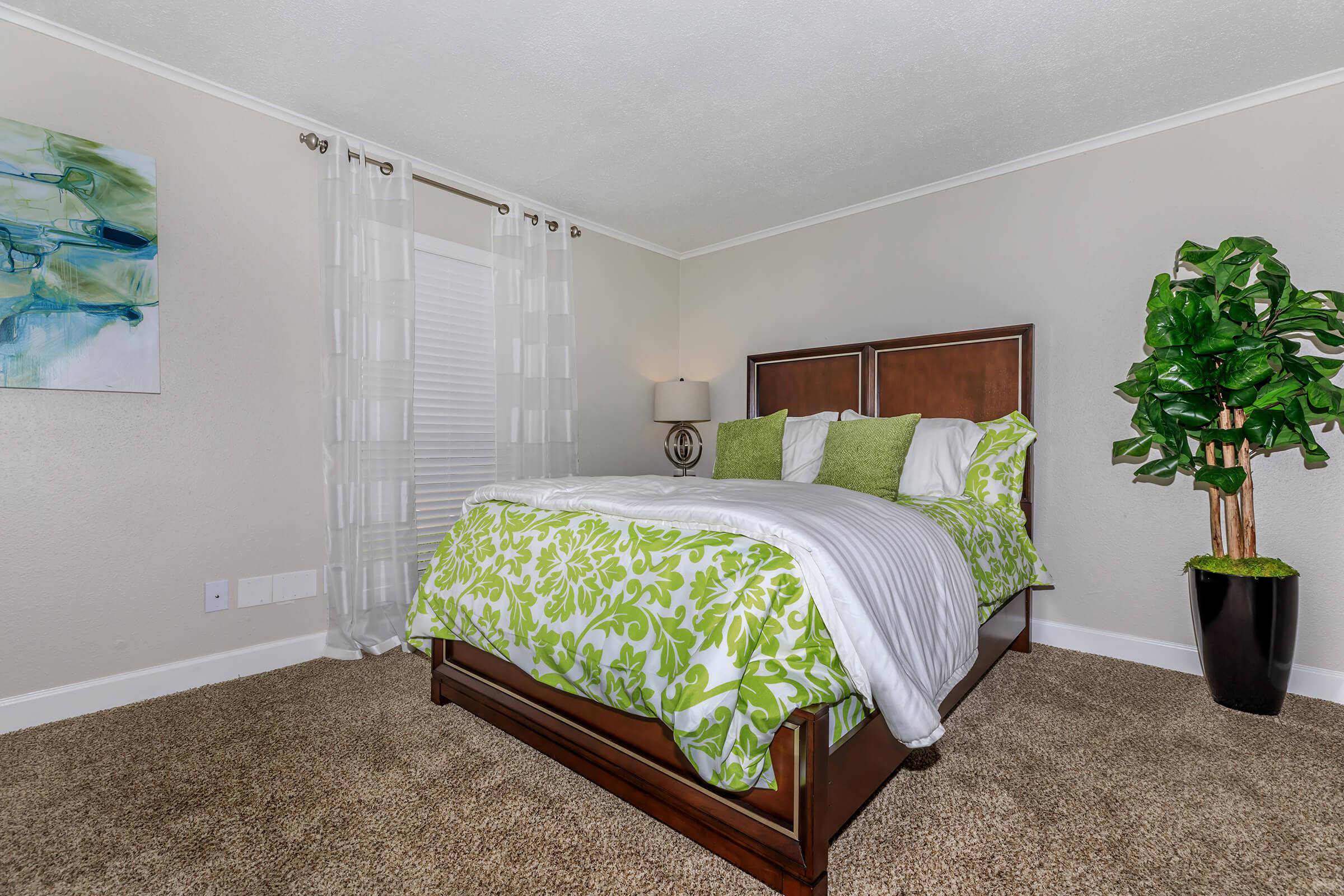 a bedroom with a bed in a room