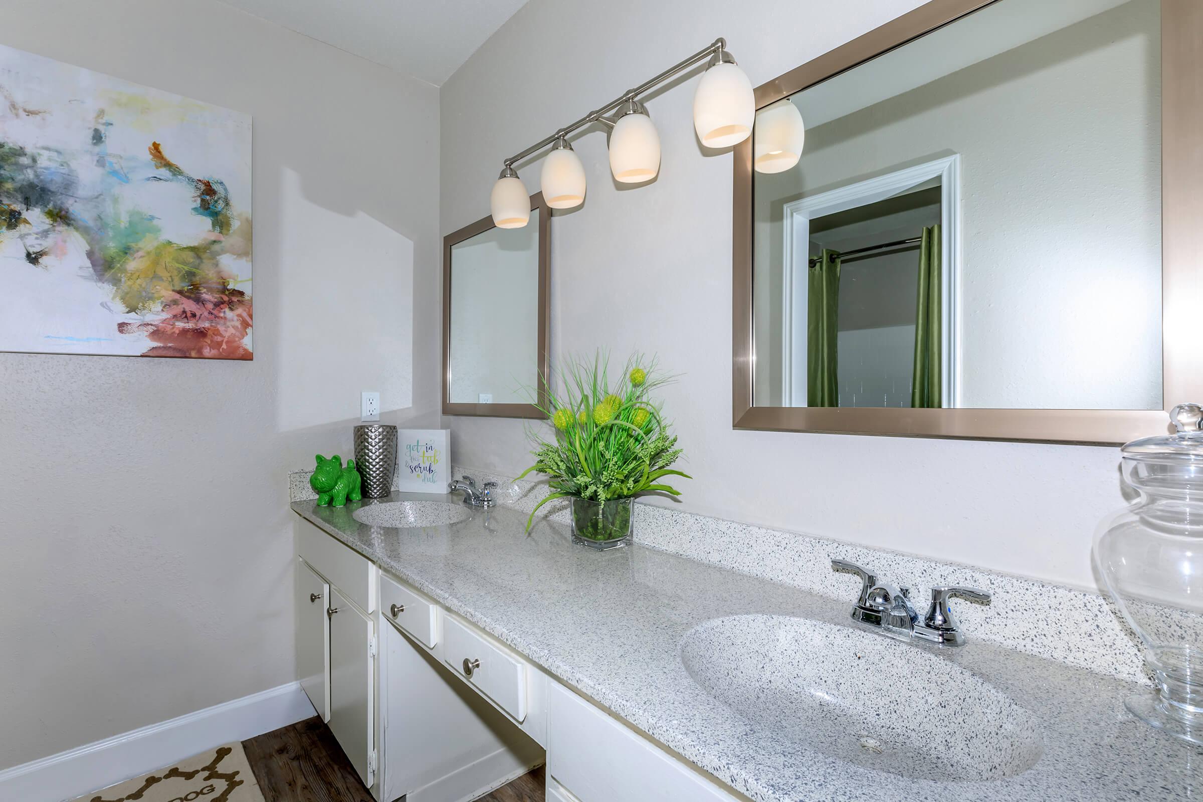 a kitchen with a sink and a mirror