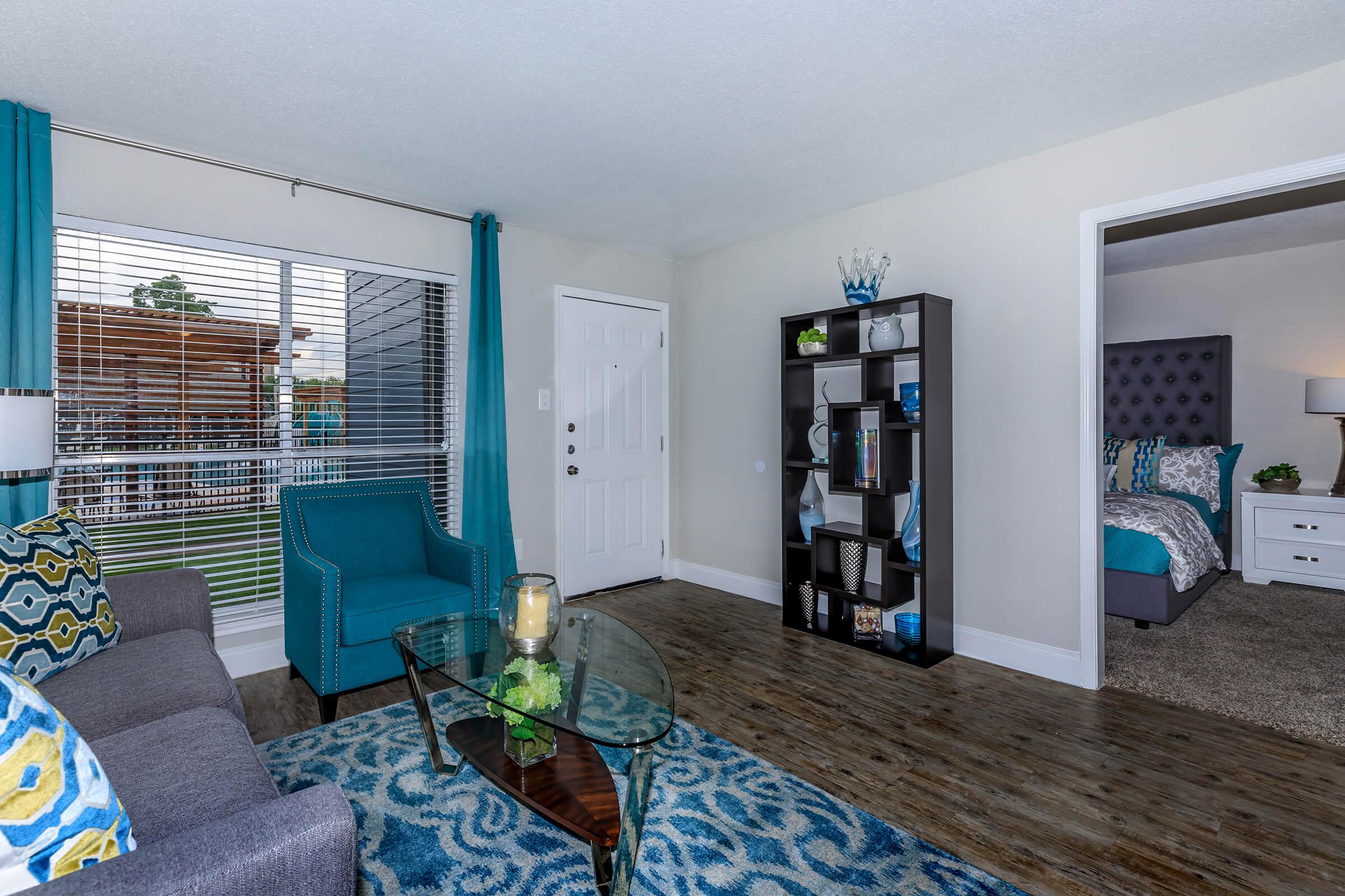 a living room filled with furniture and a flat screen tv