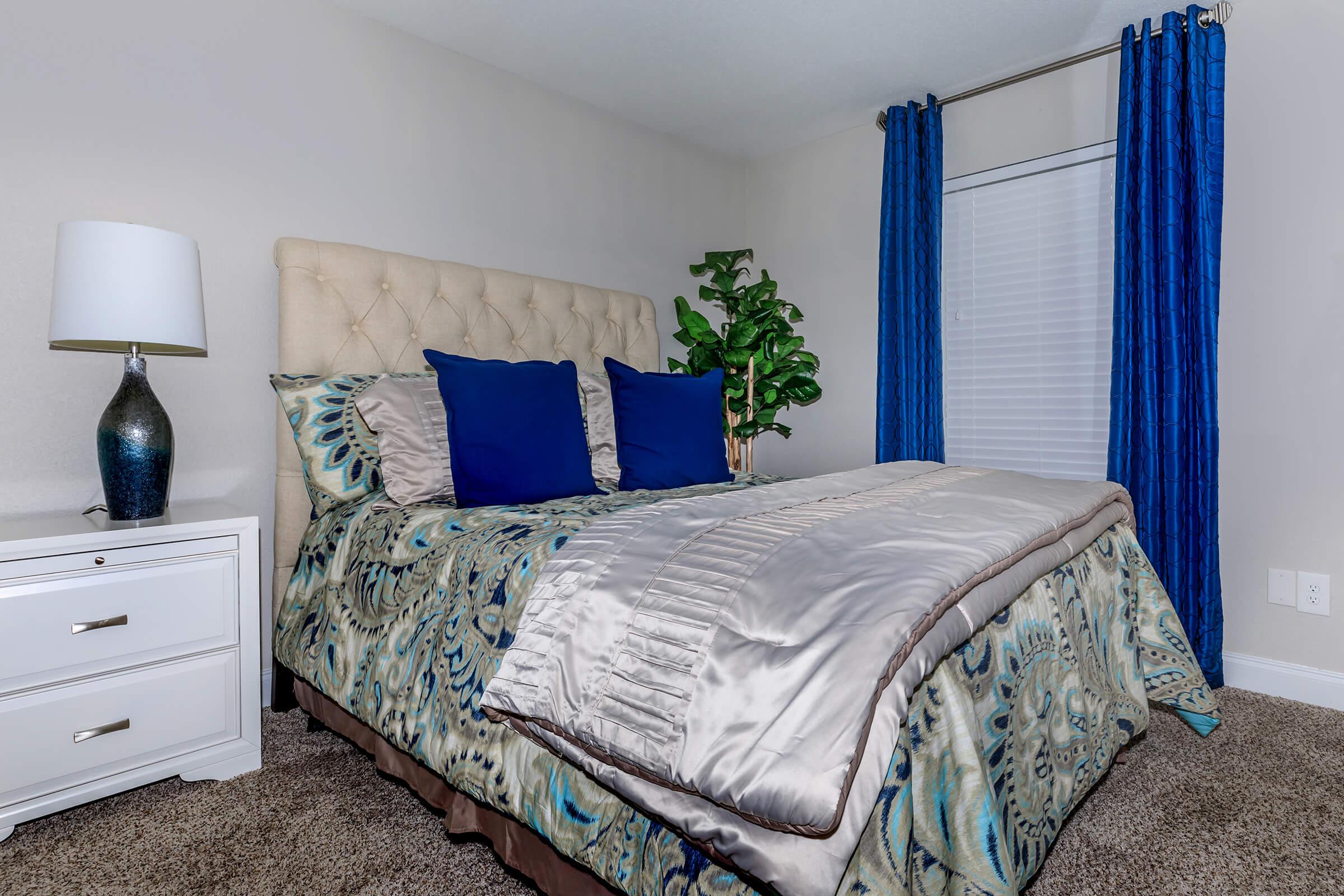 a bedroom with a bed and desk in a room