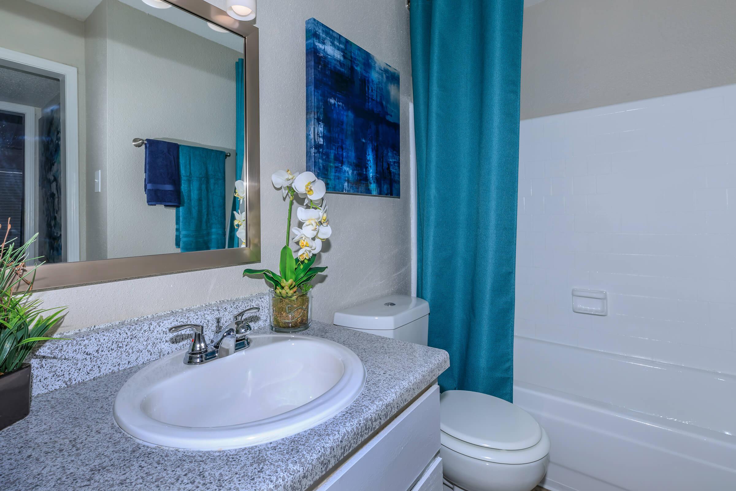 a large white tub next to a sink