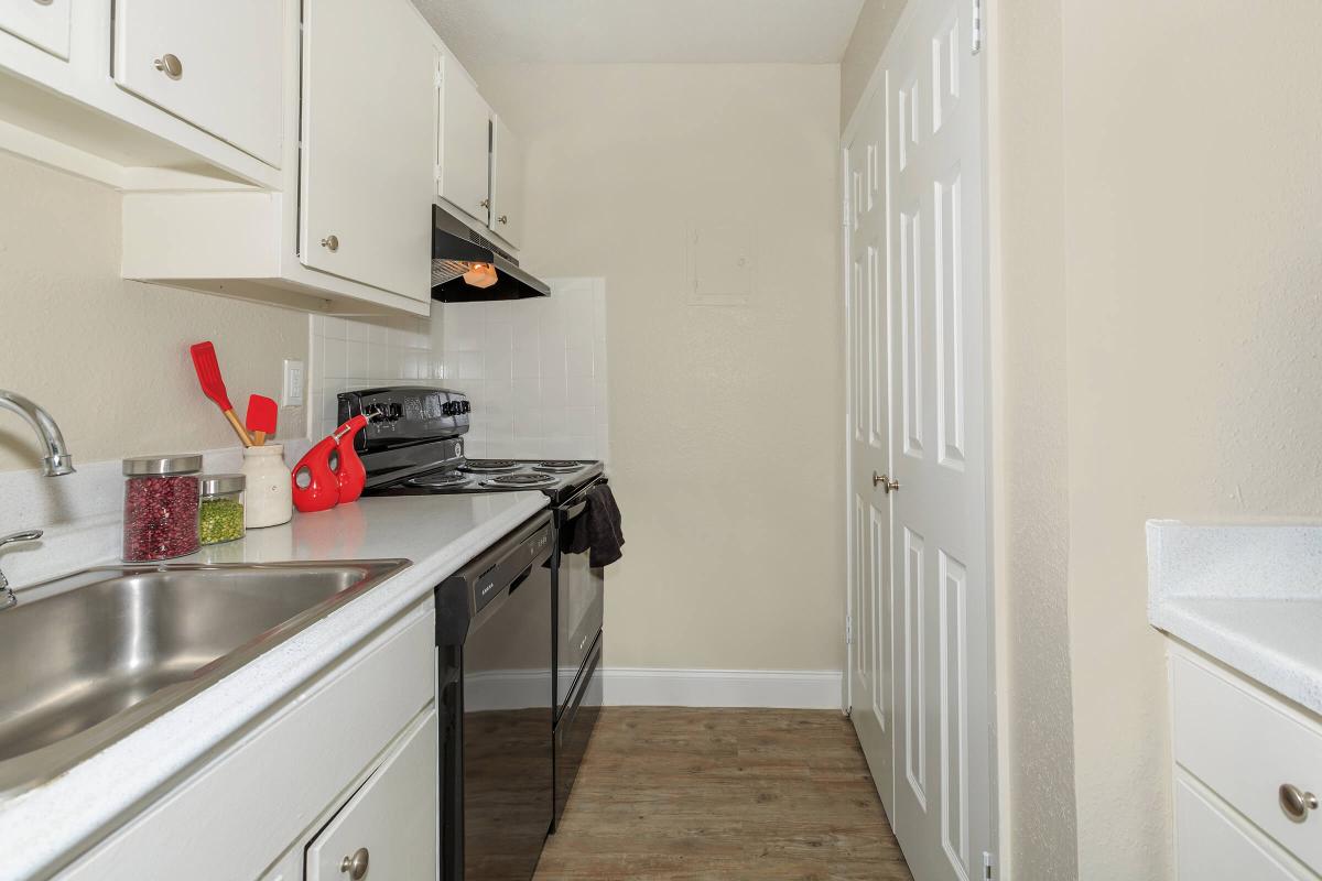 a kitchen with a stove sink and refrigerator