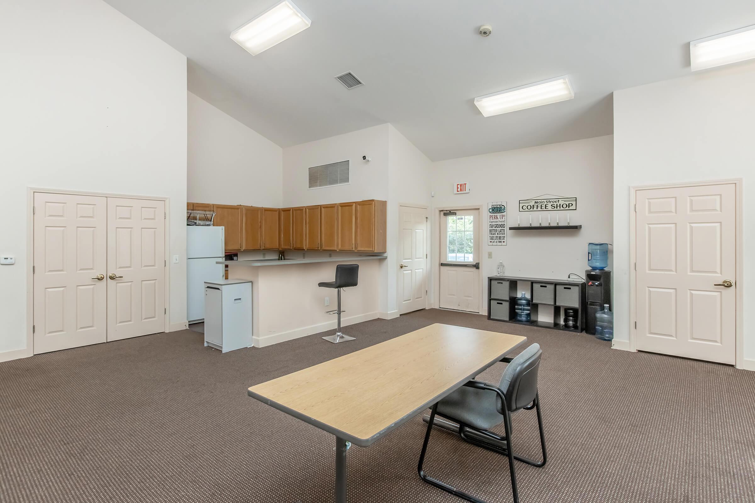 a bedroom with a bed and a chair in a room