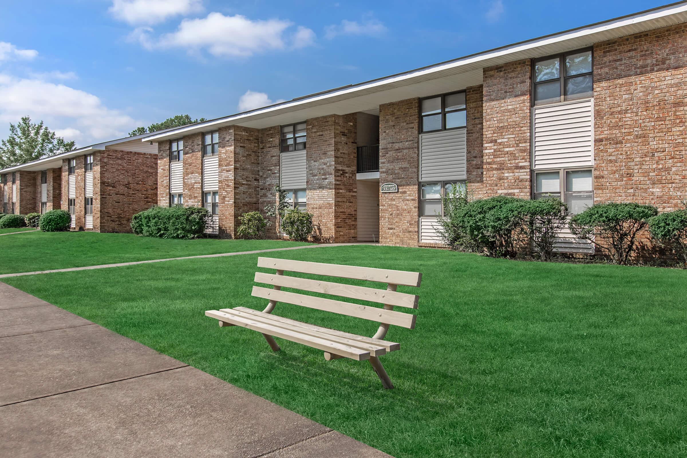 a bench in front of a brick building