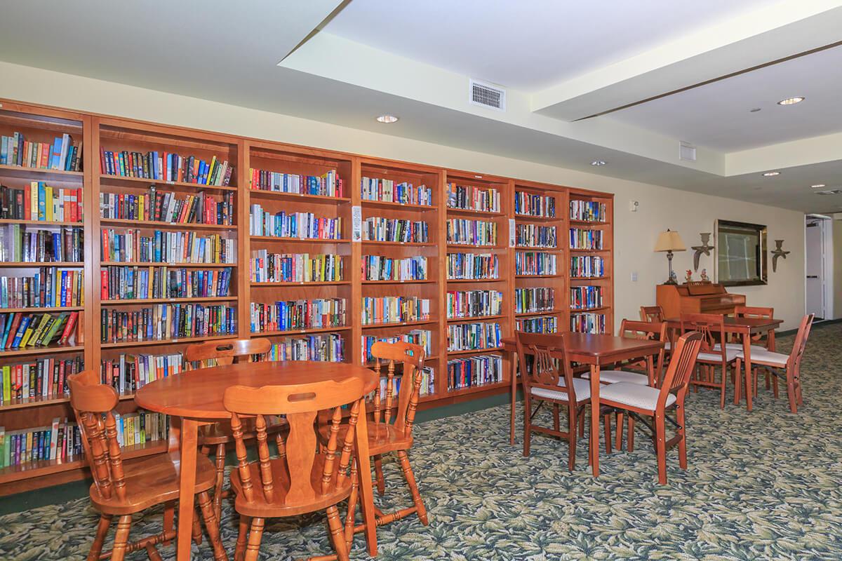 a dining room table and chairs in a library