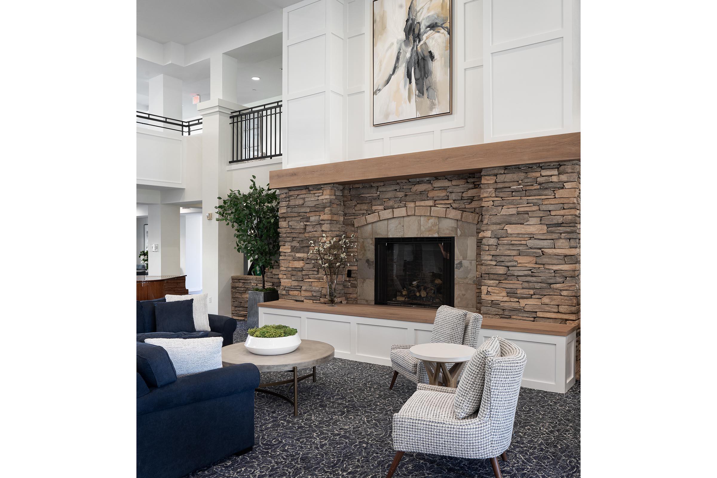 a living room with a stone wall