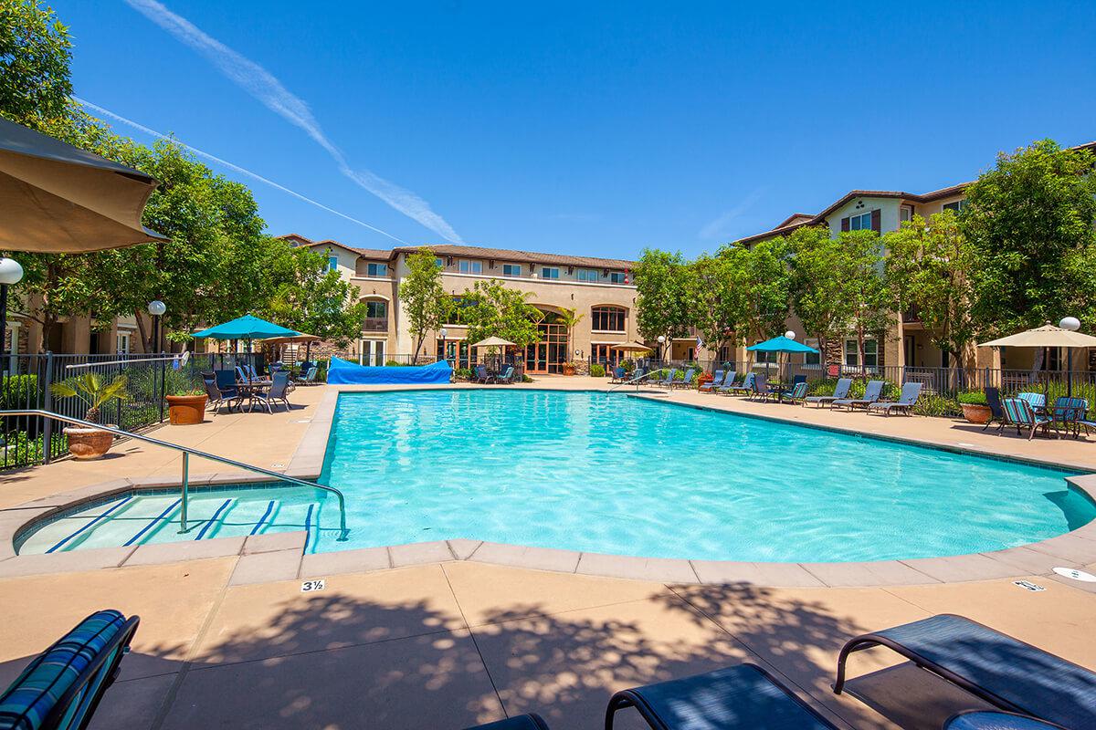 a group of lawn chairs sitting on top of a swimming pool