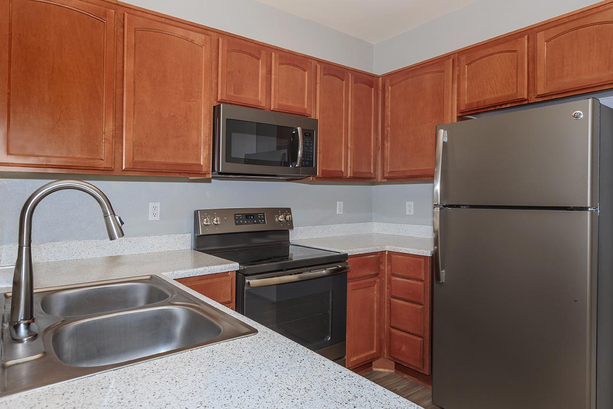 a kitchen with stainless steel appliances and wooden cabinets