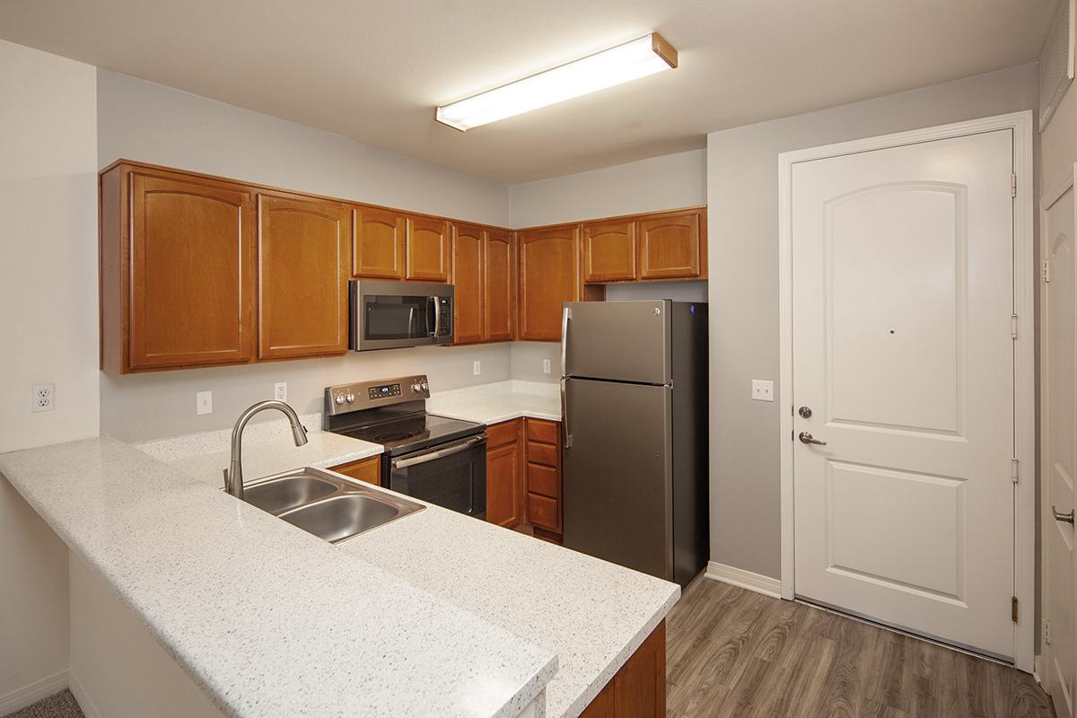 a kitchen with a sink and a refrigerator