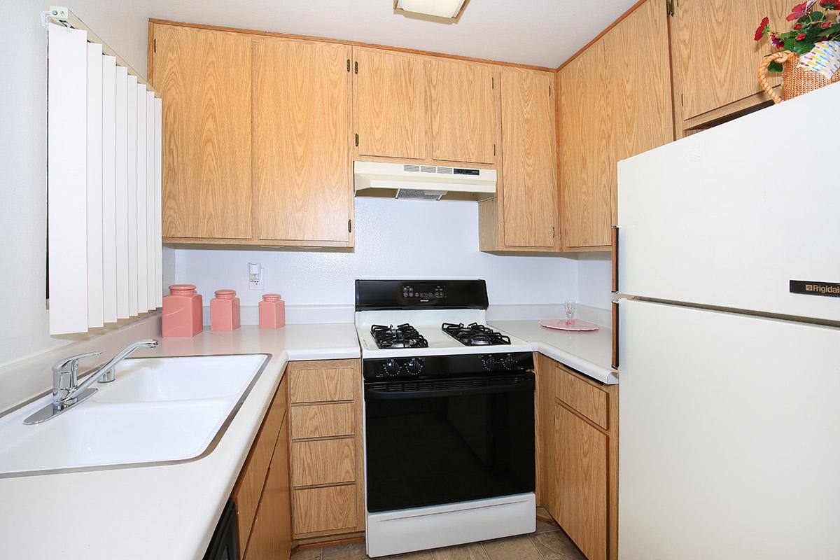 a white stove top oven sitting inside of a kitchen