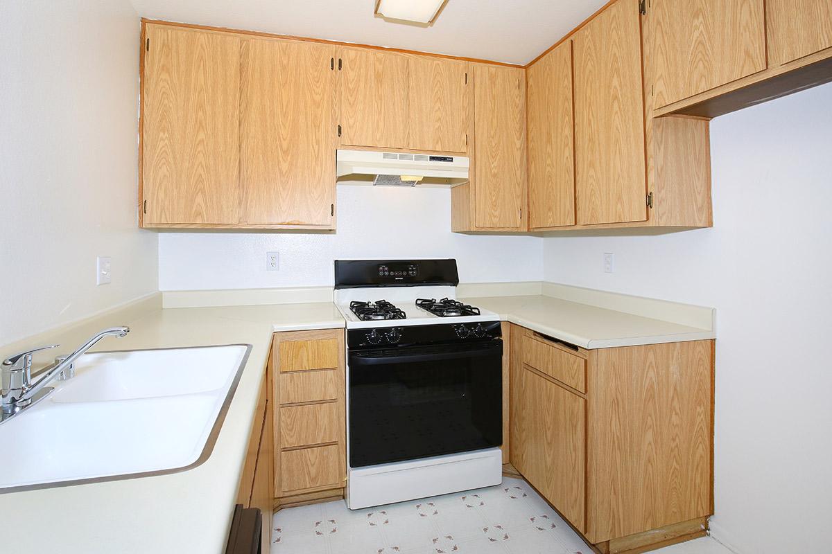 a stove top oven sitting inside of a kitchen