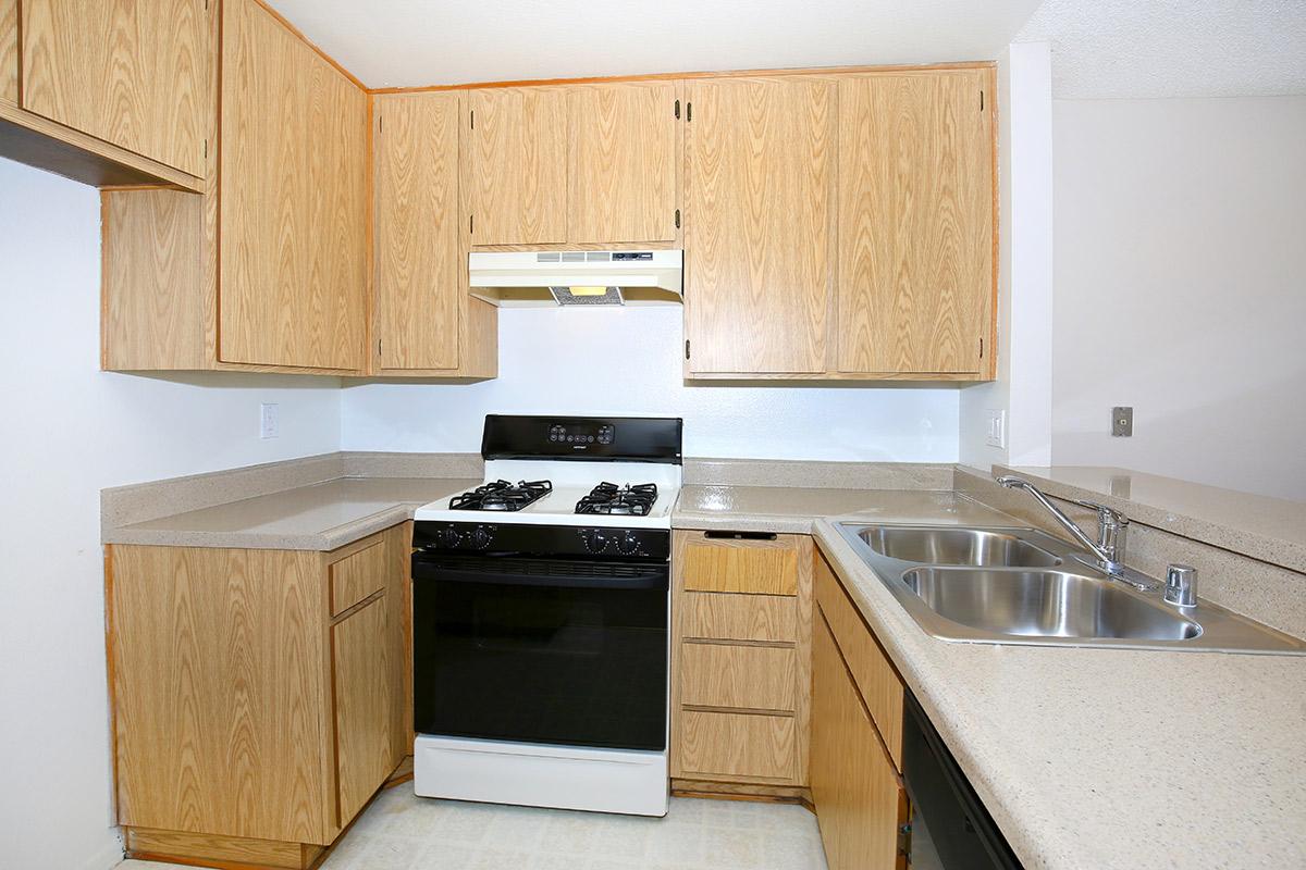 a stove top oven sitting inside of a kitchen