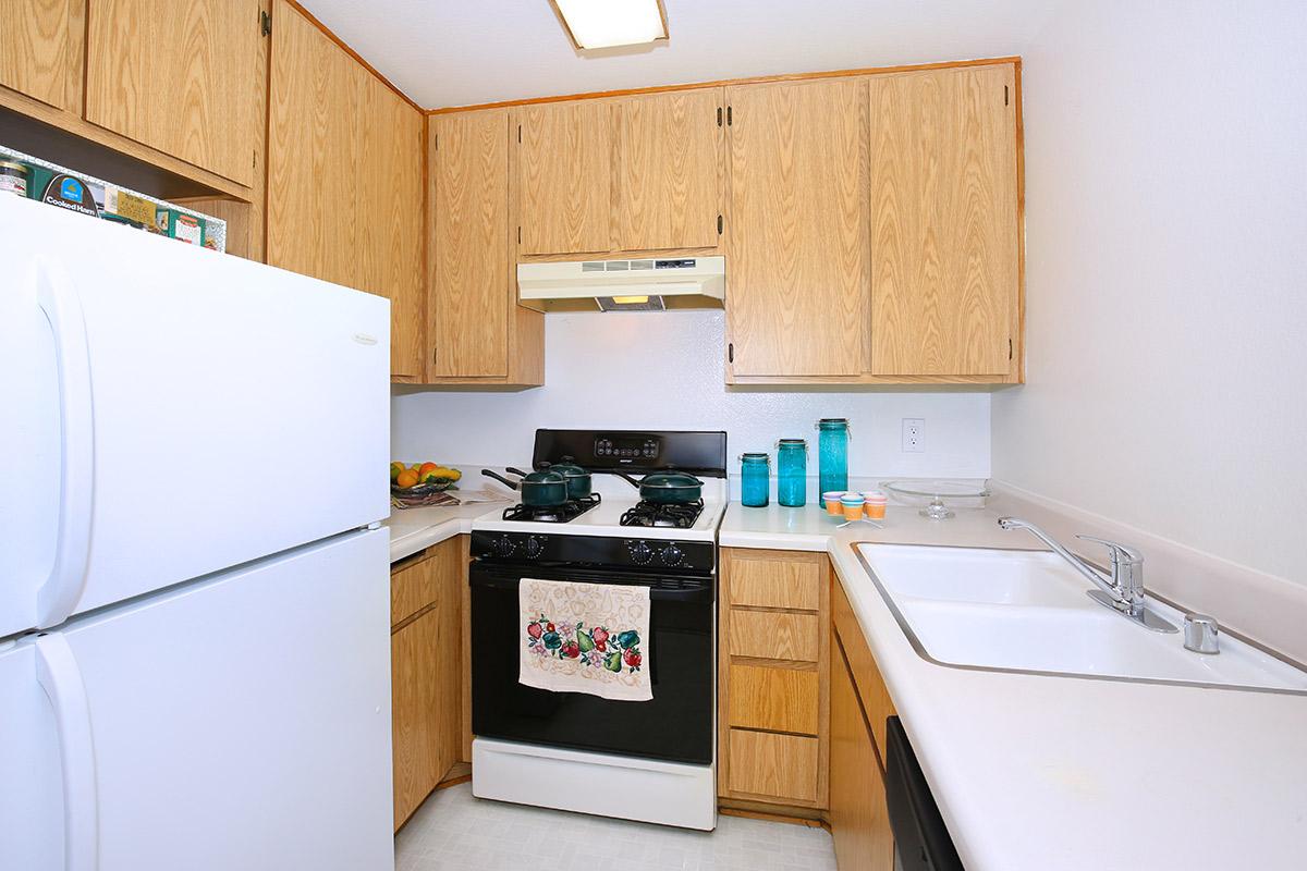 a white refrigerator freezer sitting inside of a kitchen